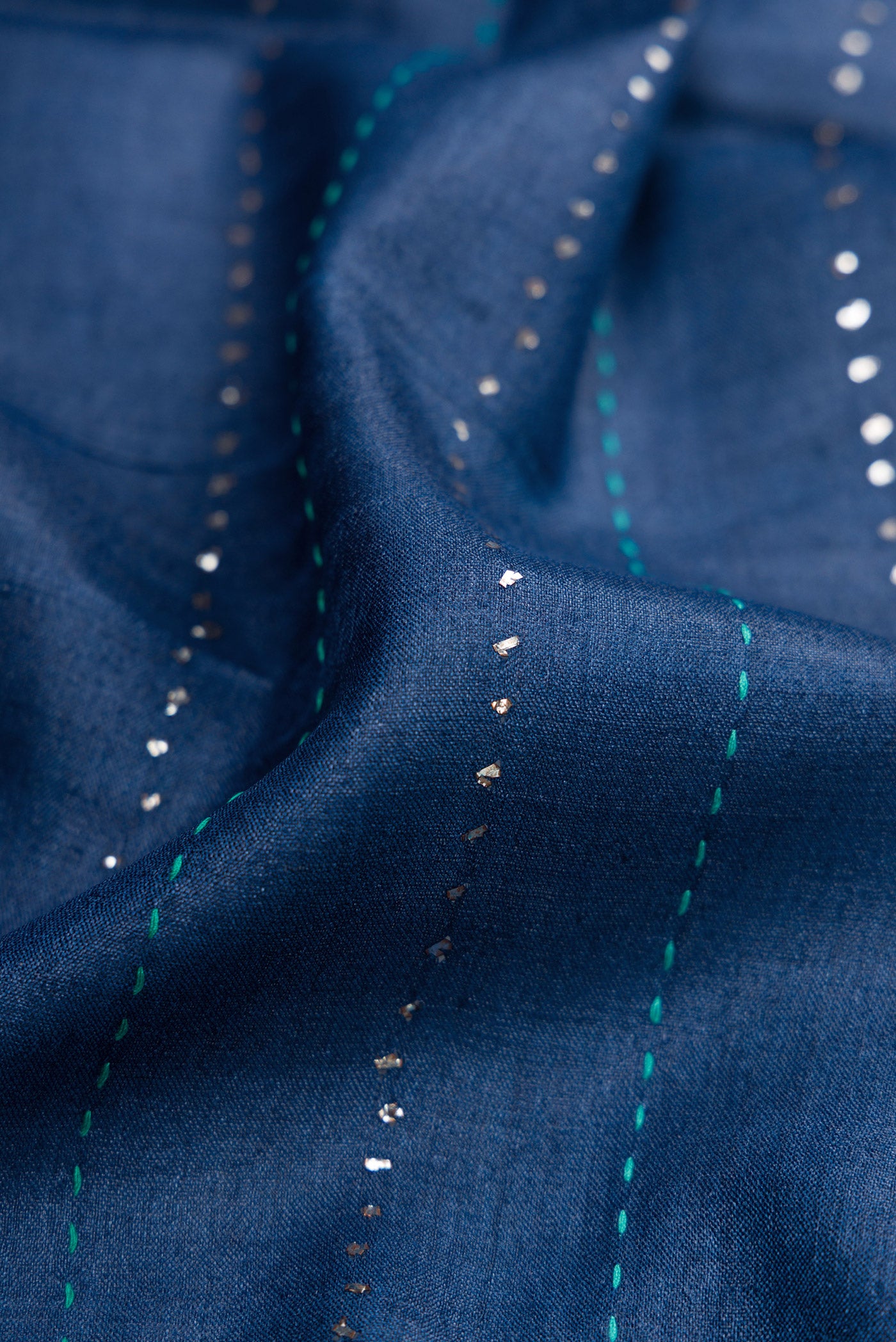 Close up of Navy Blue Dual Tone Tussar Silk Saree with Embroidery on the body and Embroidery Border.  displaying folds