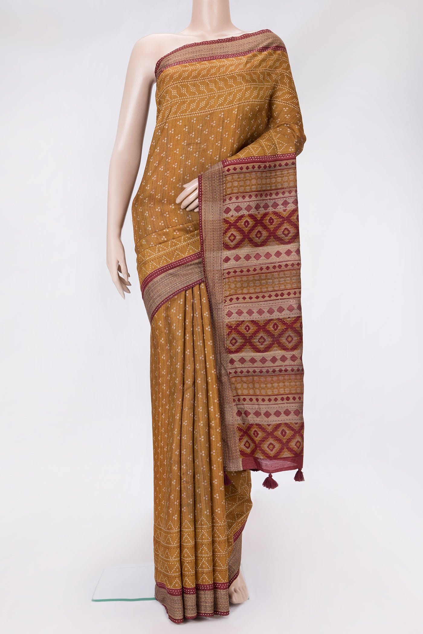 Mustard Dual Tone Tussar Silk Saree with Printed design on the body and Embroidery Border.  displayed on a mannequin