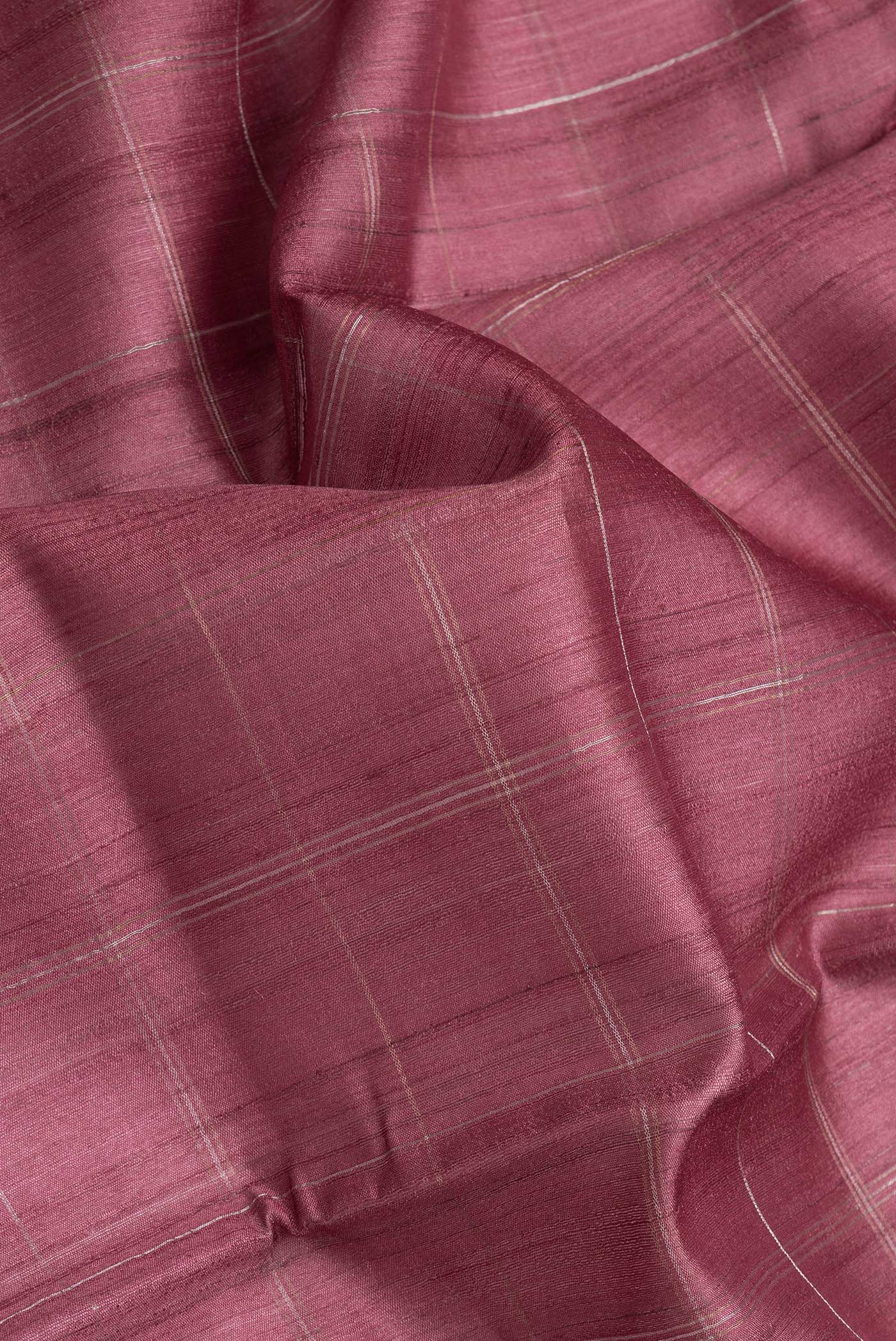 Close up of Maroon Dual Tone Tussar Silk Saree with Checked design on the body and Printed Border.  displaying folds