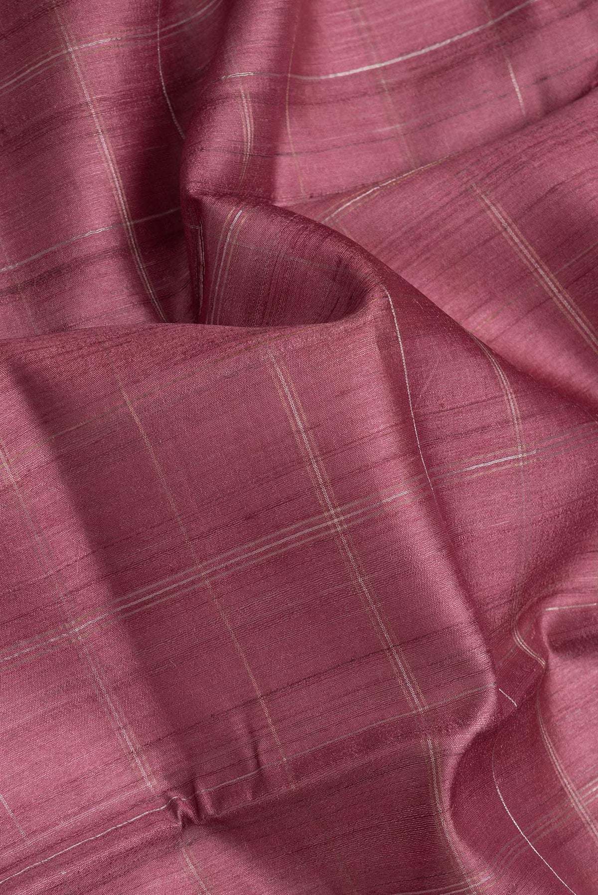 Close up of Maroon Dual Tone Tussar Silk Saree with Checked design on the body and Printed Border.  displaying folds