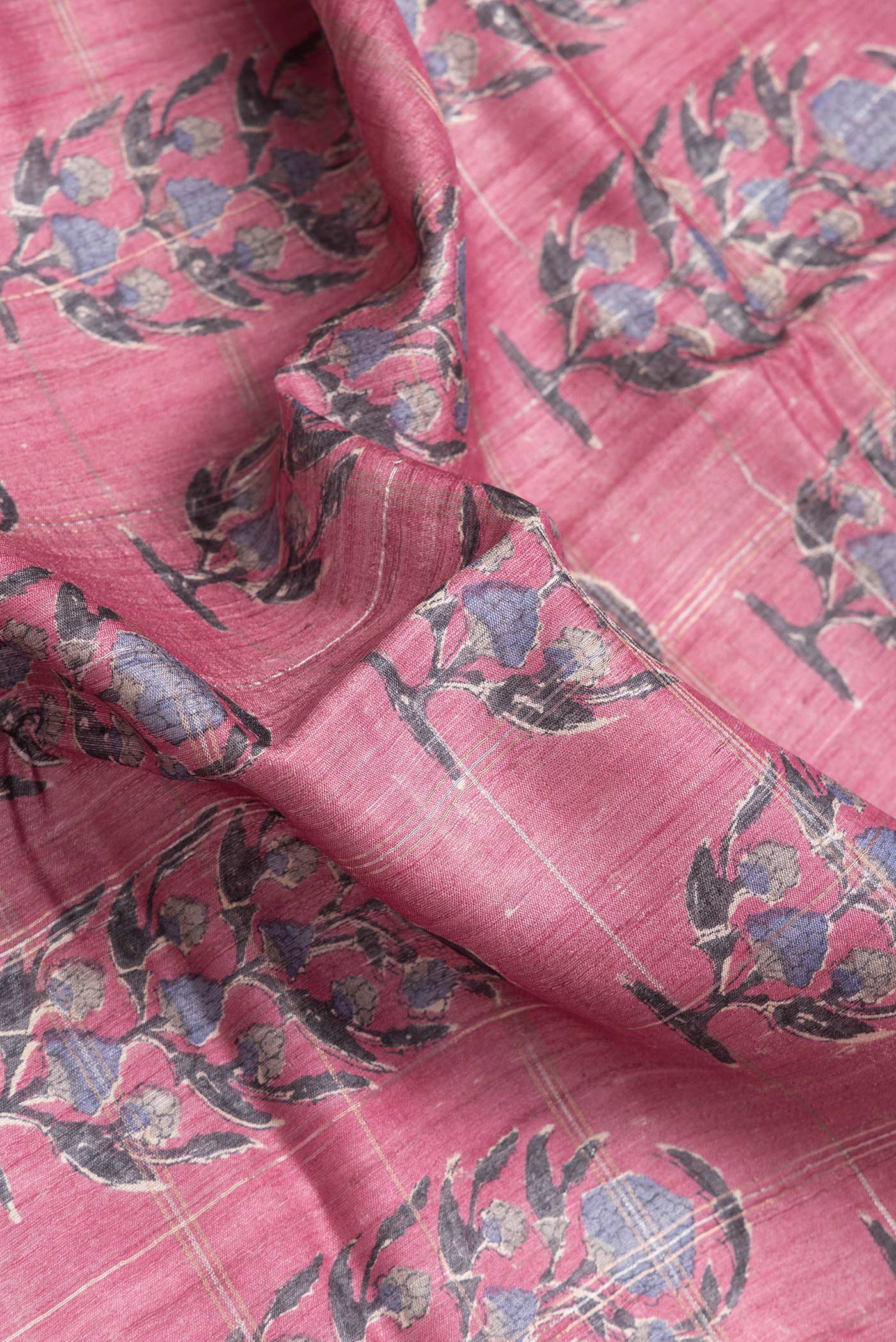 Close up of Pink Dual Tone Tussar Silk Saree with Printed design on the body and Zari Border.  displaying folds