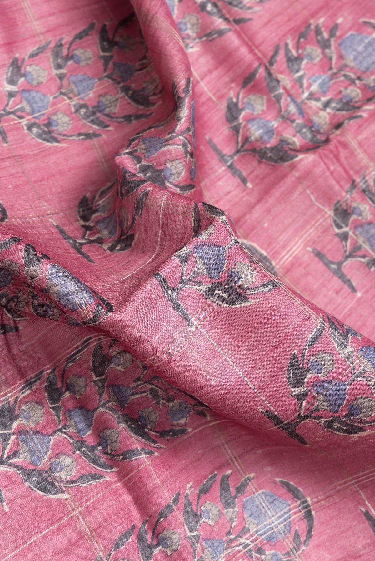 Close up of Pink Dual Tone Tussar Silk Saree with Printed design on the body and Zari Border.  displaying folds