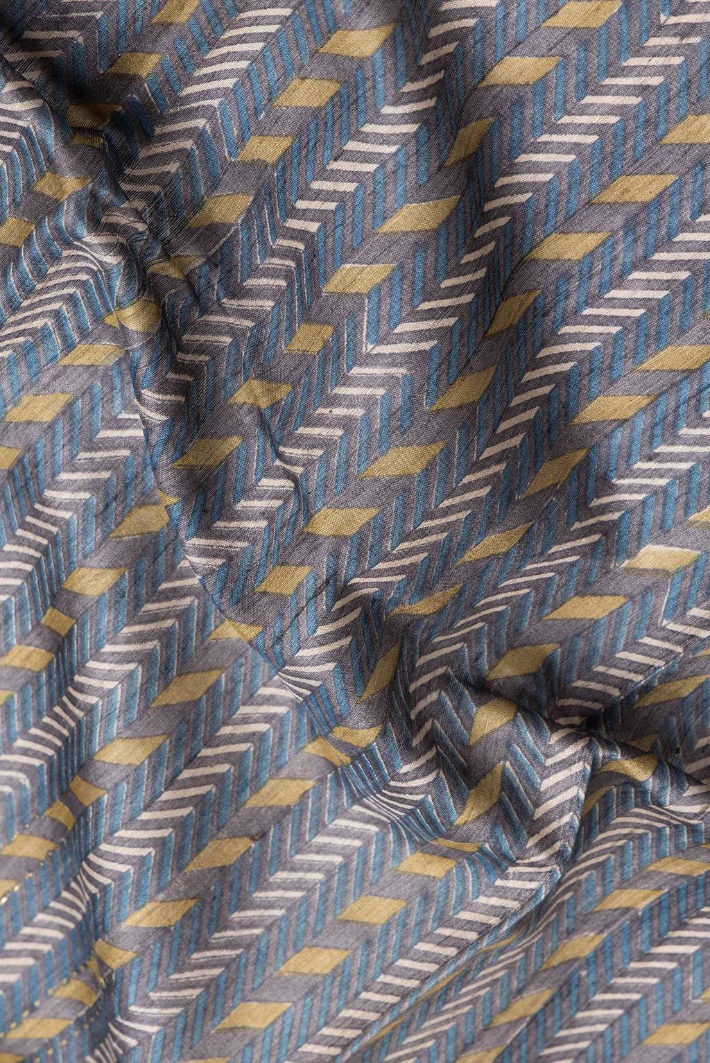 Close up of Navy Blue Dual Tone Tussar Silk Saree with Printed design on the body and Zari And Thread Border.  displaying folds