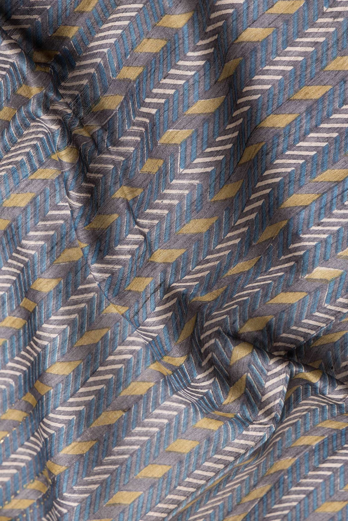 Close up of Navy Blue Dual Tone Tussar Silk Saree with Printed design on the body and Zari And Thread Border.  displaying folds