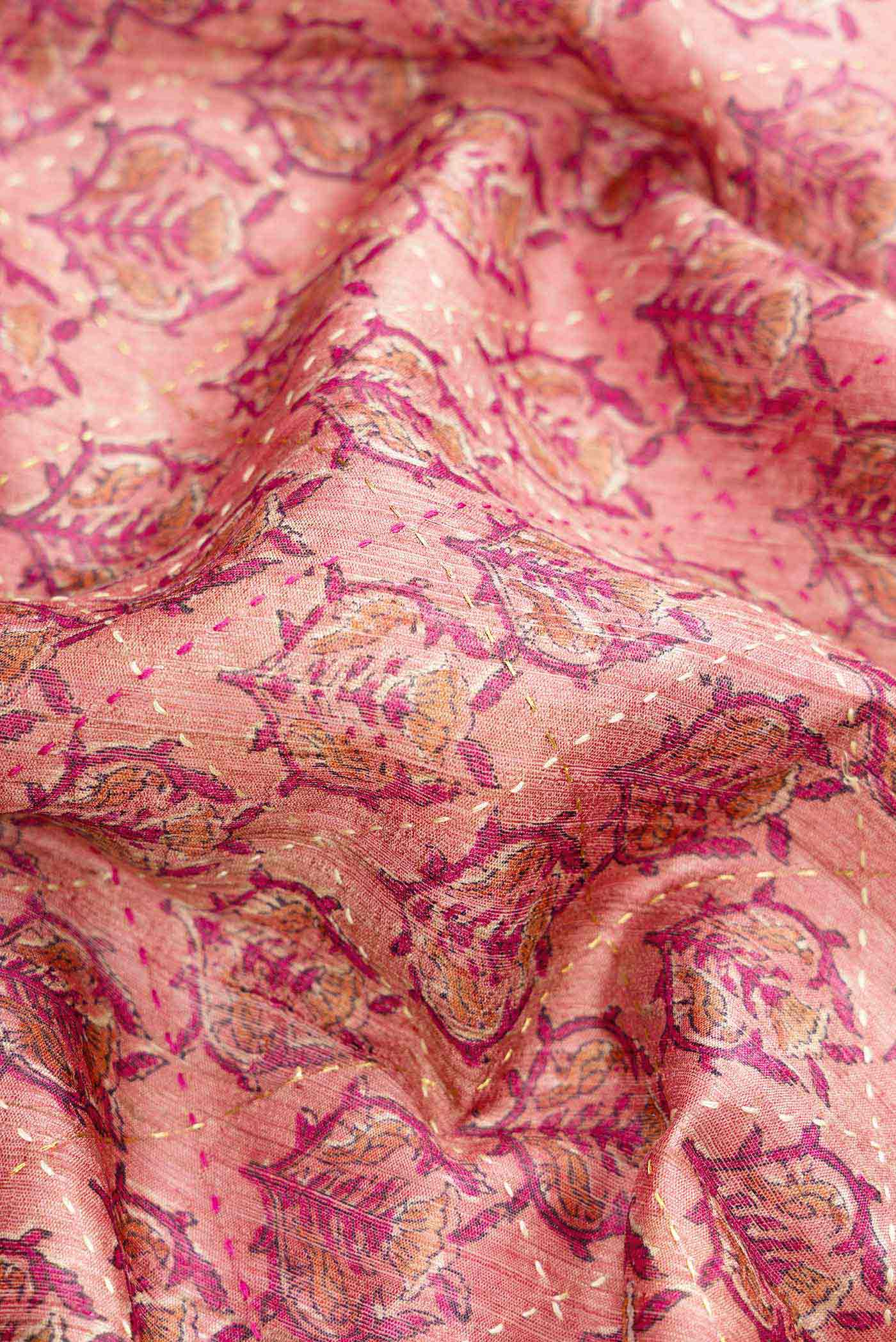 Close up of Golden Peach Dual Tone Tussar Silk Saree with Printed design on the body and Embroidery Border.  displaying folds