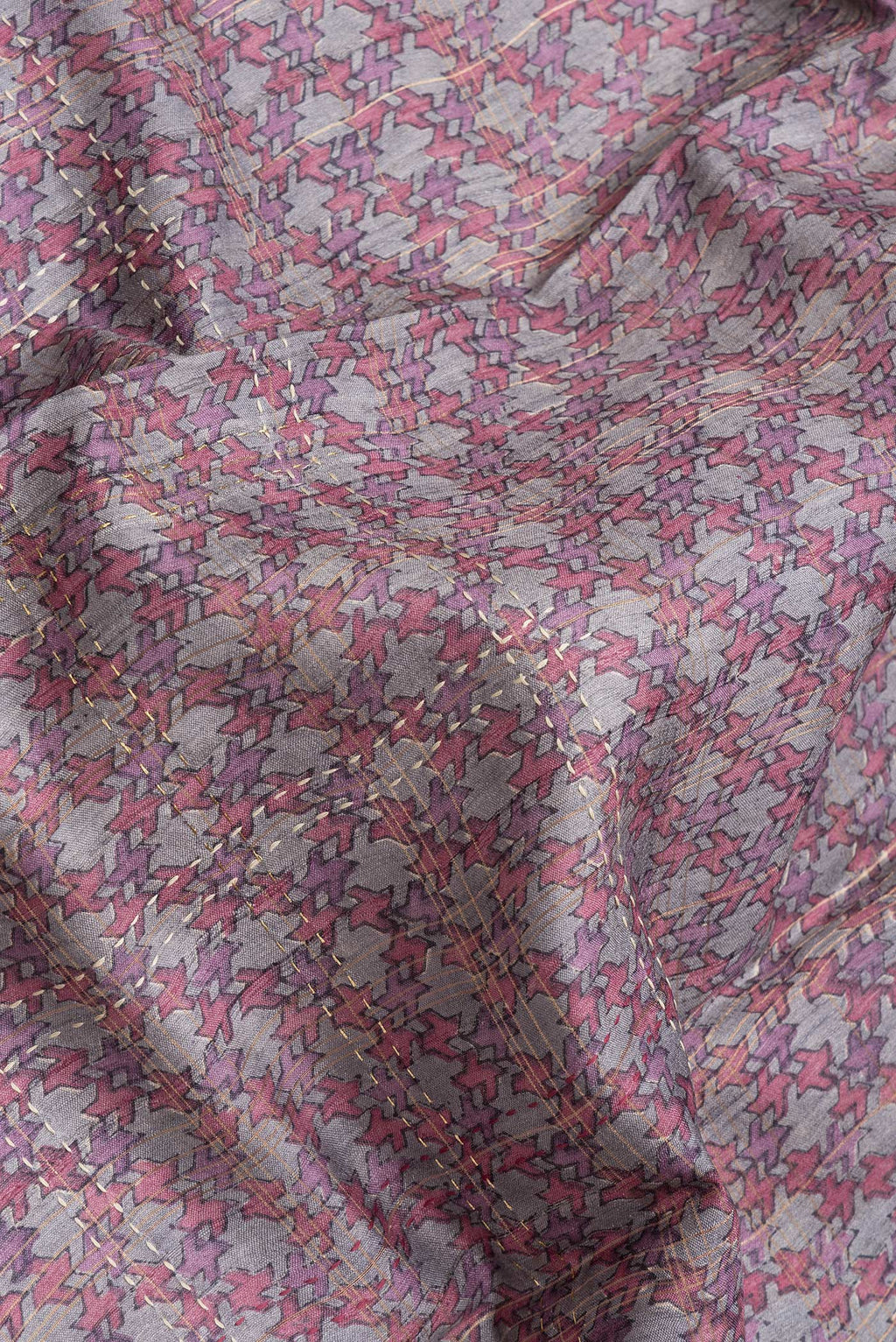 Close up of Grey Dual Tone Tussar Silk Saree with Printed design on the body and Printed Border.  displaying folds