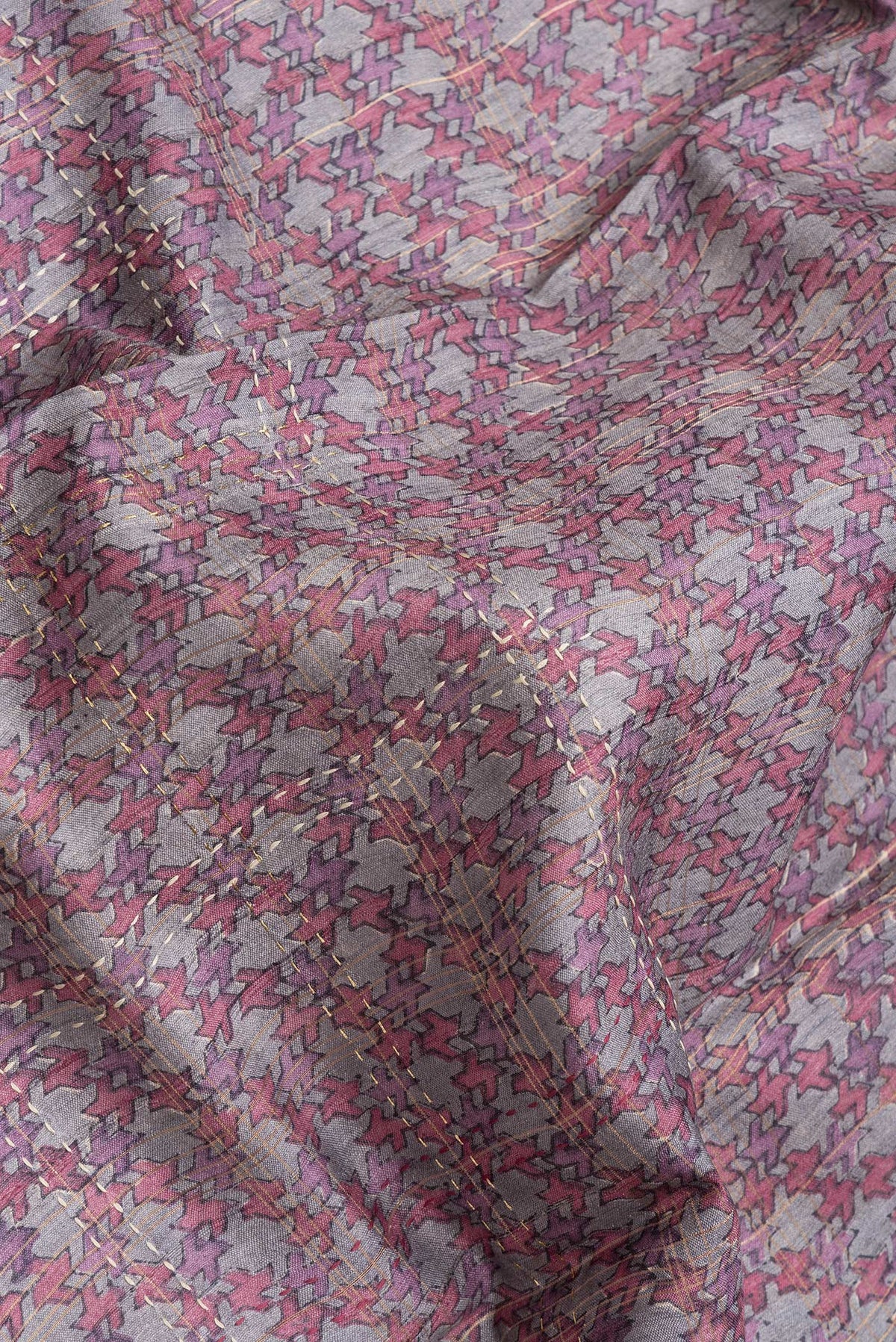 Close up of Grey Dual Tone Tussar Silk Saree with Printed design on the body and Printed Border.  displaying folds