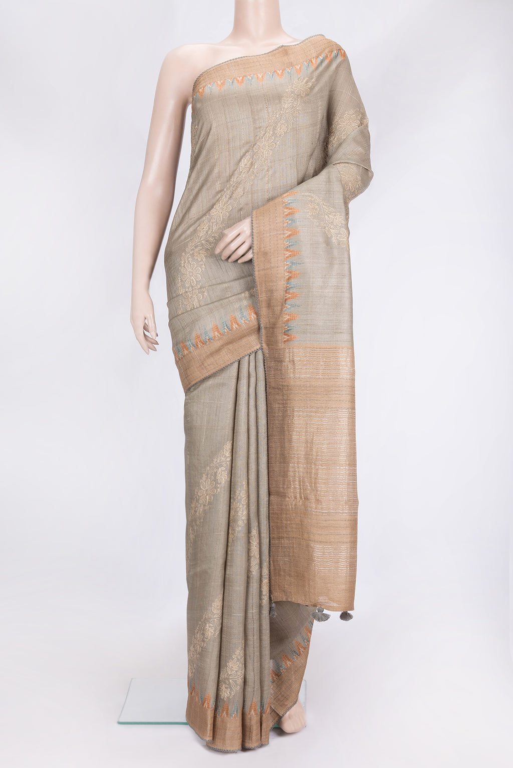 Beige Dual Tone Tussar Silk Saree with Embroidery on the body and Embroidery Border.  displayed on a mannequin