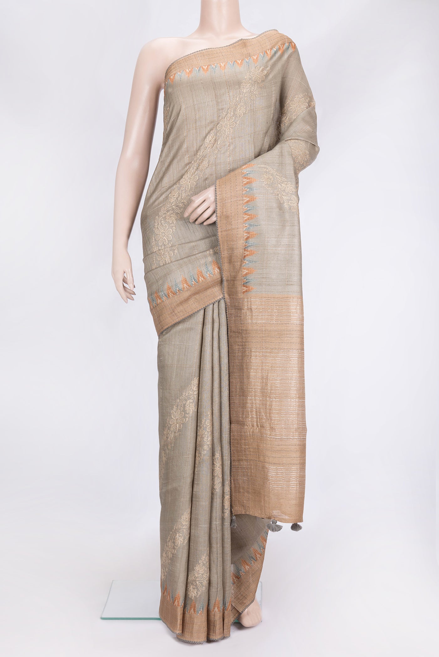 Beige Dual Tone Tussar Silk Saree with Embroidery on the body and Embroidery Border.  displayed on a mannequin
