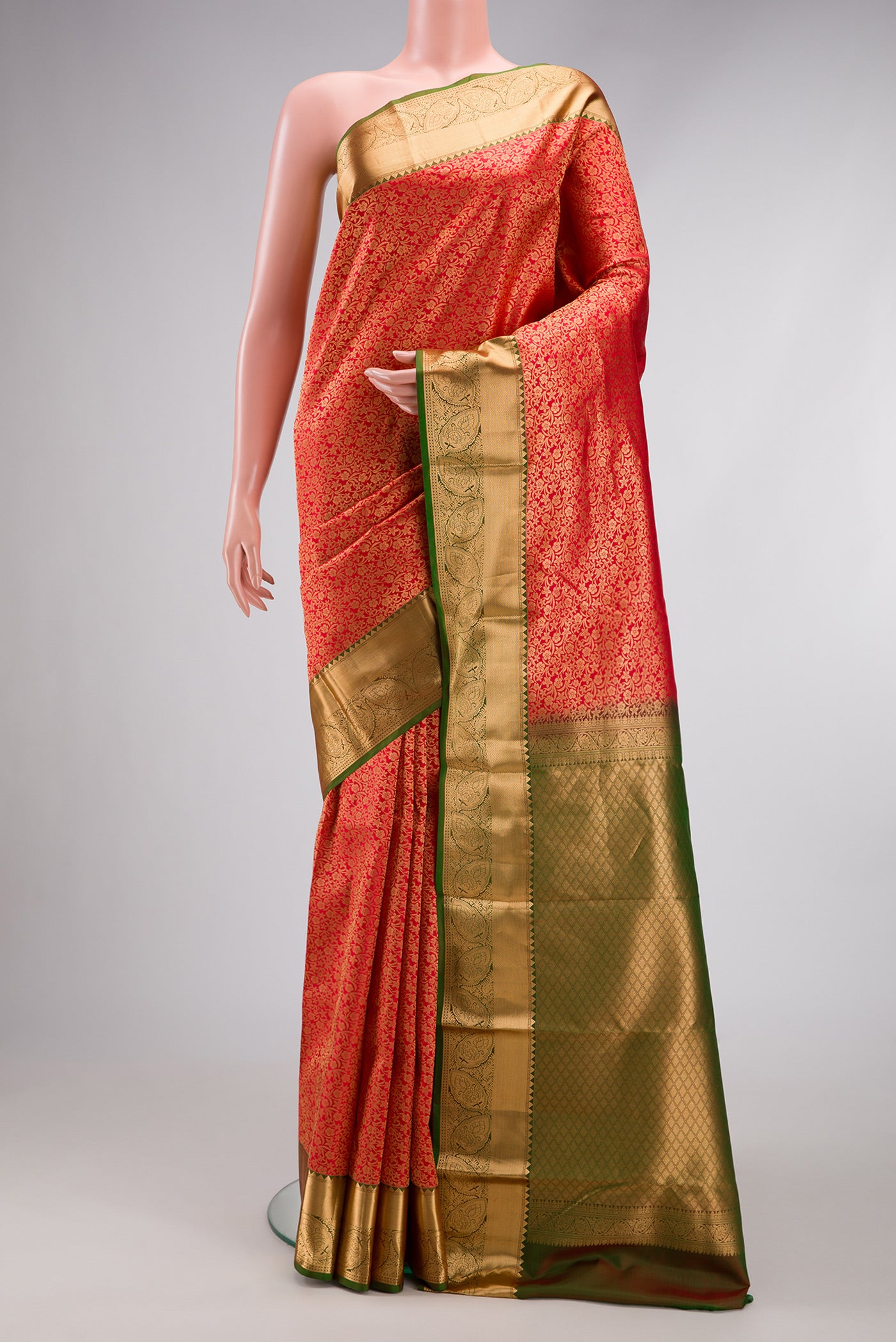Red Kanchipuram Silk Saree with Zari Brocade on the body and Zari Border.  displayed on a mannequin