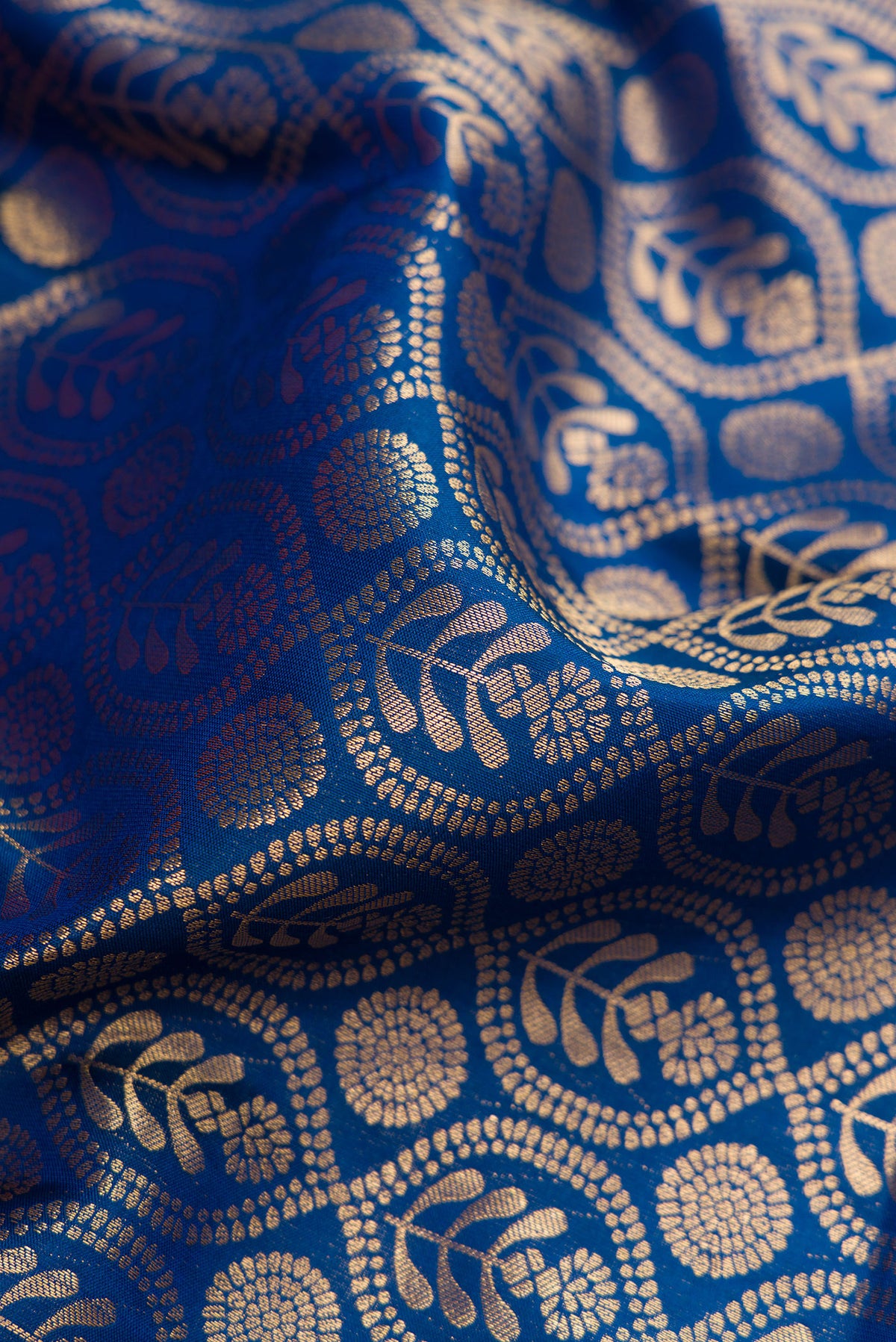 Close up of Peacock Blue Kanjivaram Silk Saree with Zari Brocade on the body and Zari Border.  displaying folds