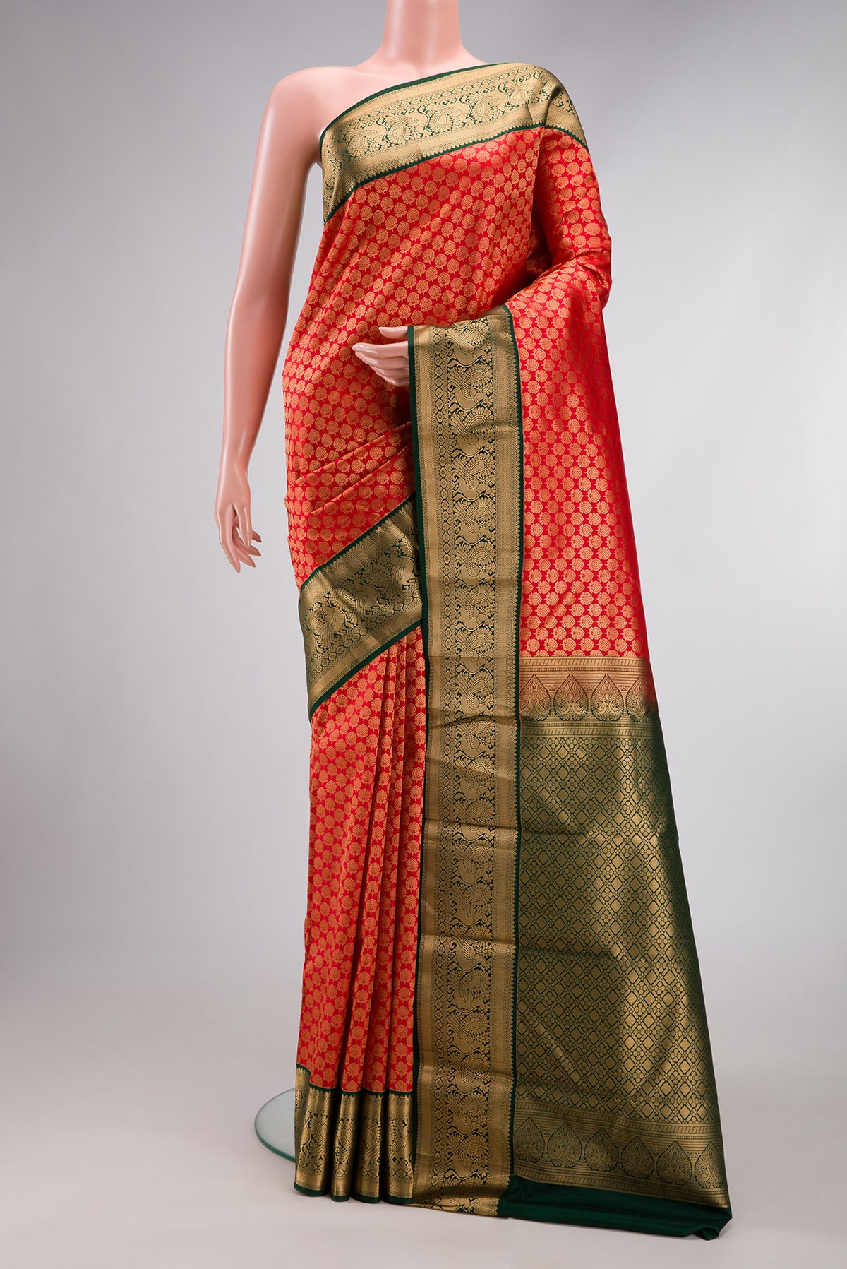 Red Kanjivaram Silk Saree with Zari Brocade on the body and Zari Border.  displayed on a mannequin