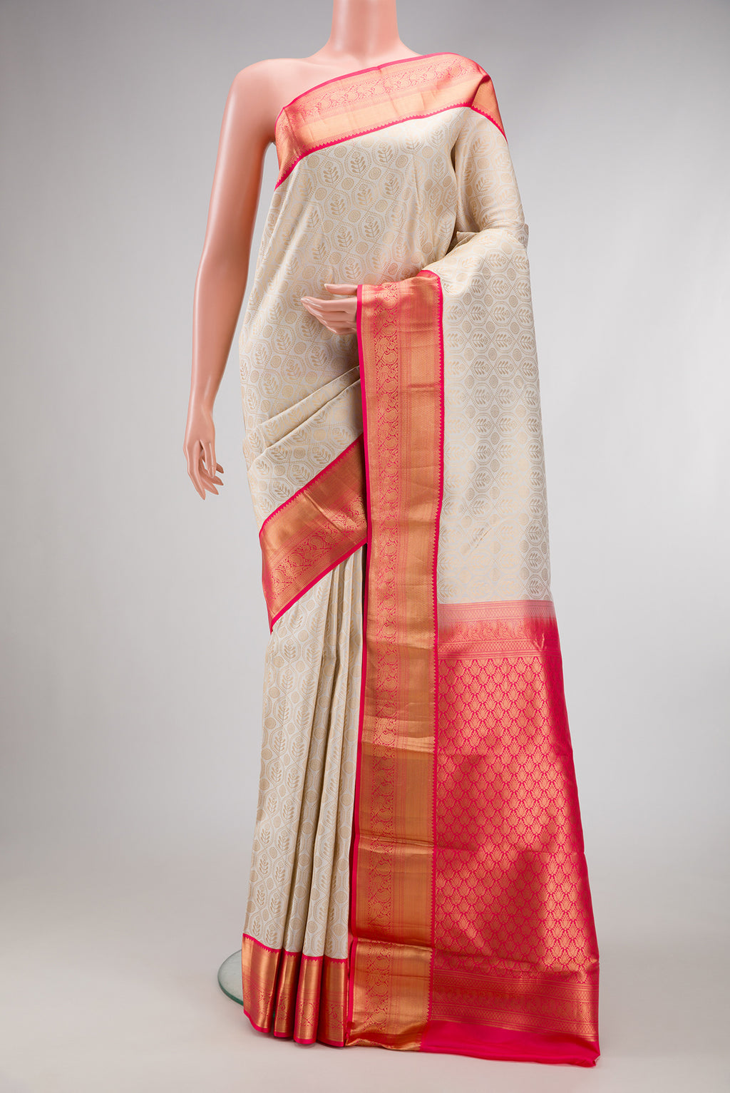Off White Kanjivaram Silk Saree with Zari Brocade on the body and Zari Border.  displayed on a mannequin