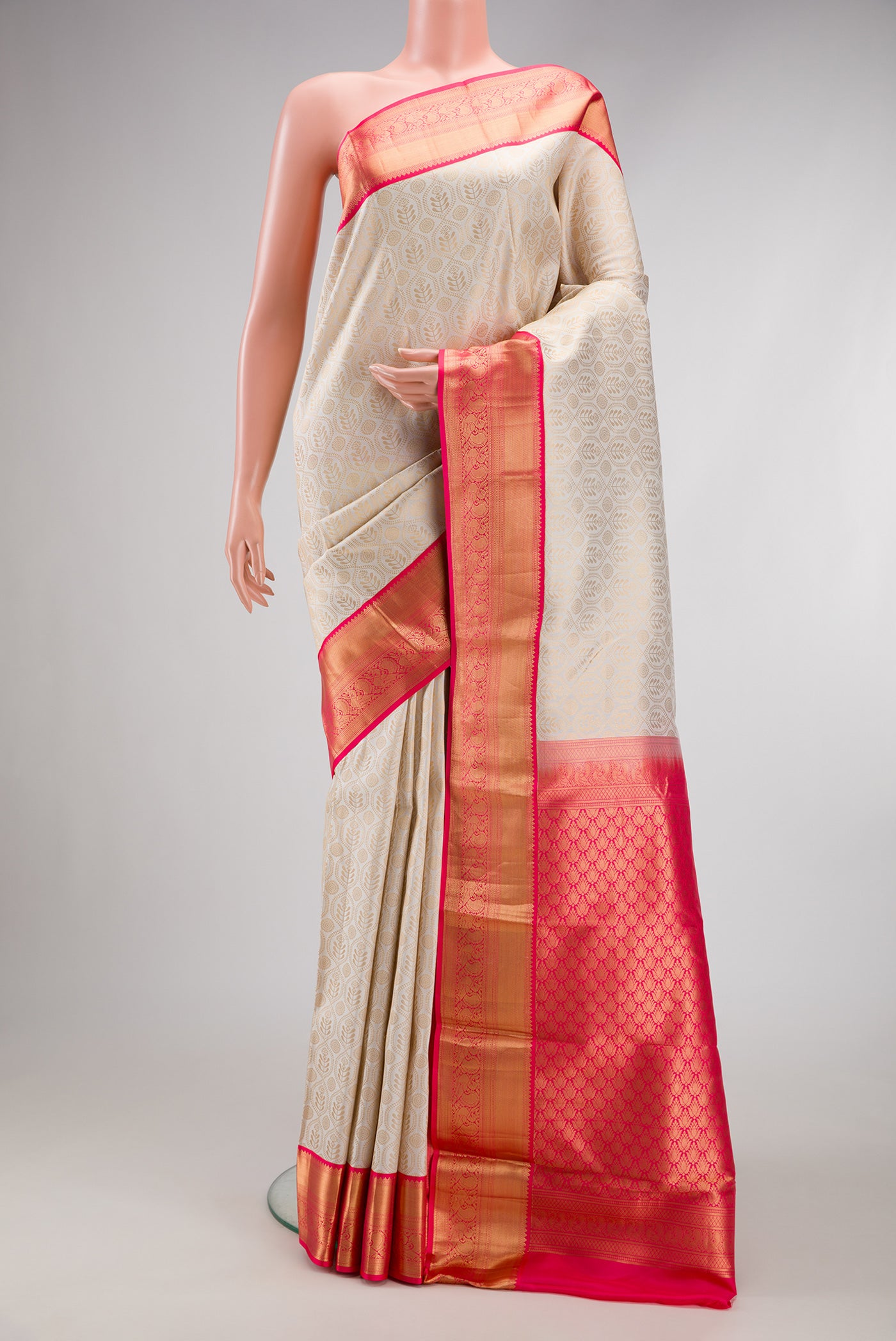 Off White Kanjivaram Silk Saree with Zari Brocade on the body and Zari Border.  displayed on a mannequin
