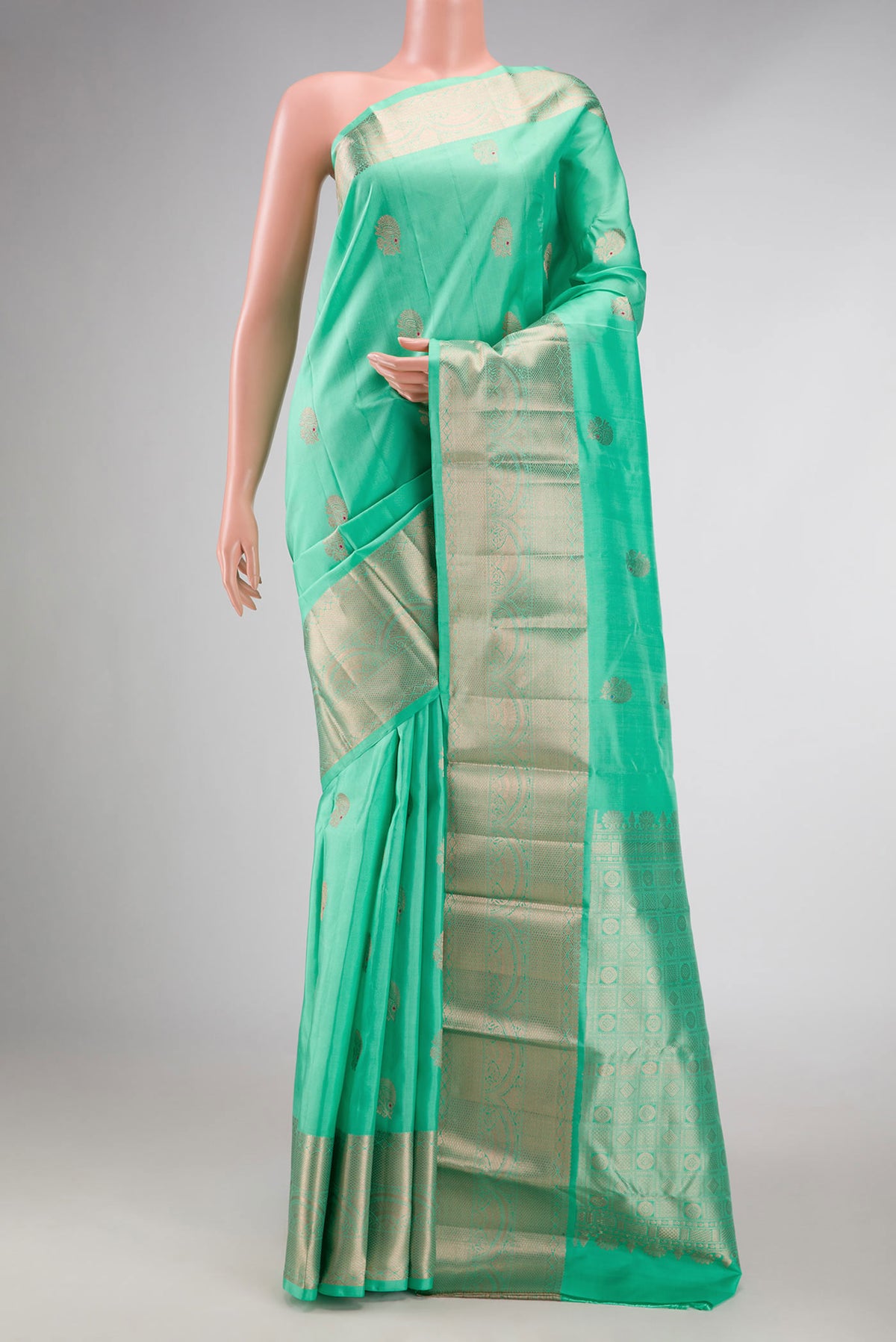 Light Green Dual Tone Kanchipuram Silk Saree with Zari Butta on the body and Zari Border displayed on a mannequin