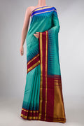 Green Dual Tone Kanchipuram Silk Saree with Zari Butta on the body and Ganga Jamuna Border displayed on a mannequin