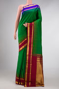 Green Dual Tone Kanchipuram Silk Saree with Plain Body and Ganga Jamuna Border displayed on a mannequin