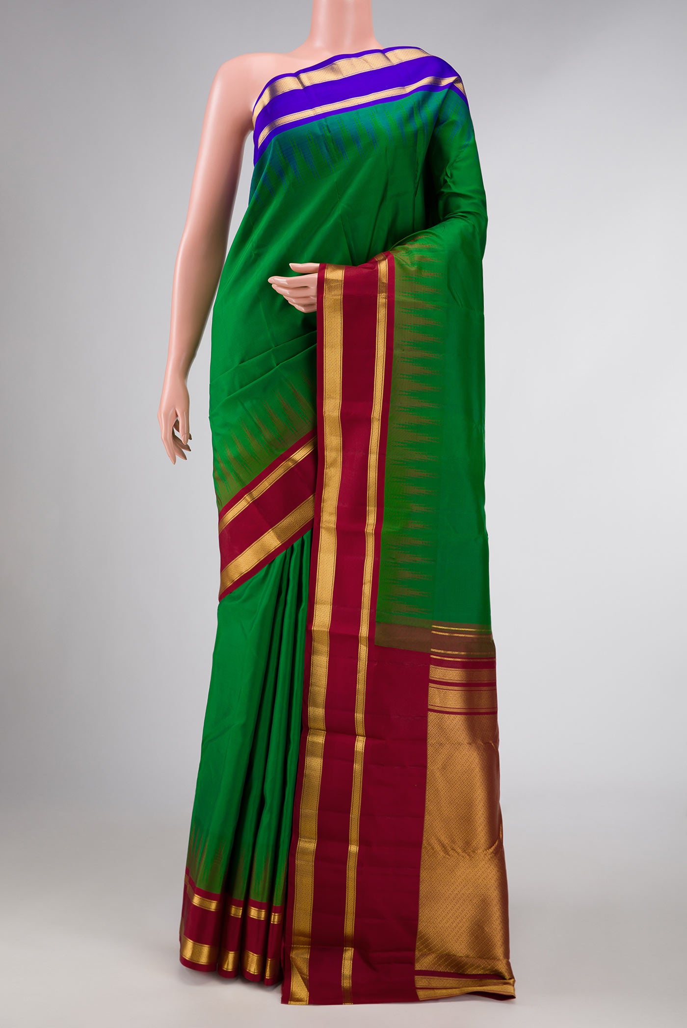 Green Dual Tone Kanchipuram Silk Saree with Plain Body and Ganga Jamuna Border displayed on a mannequin