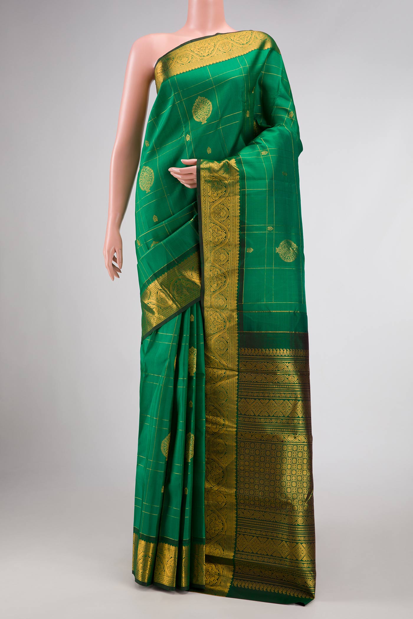 Green Dual Tone Kanchipuram Silk Saree with Zari Butta on the body and Zari Border displayed on a mannequin