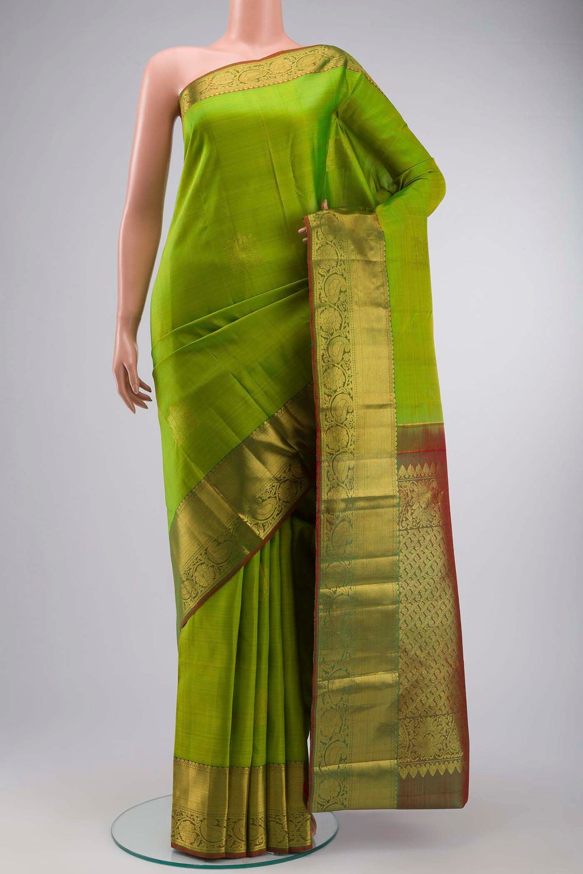 Green Kanchipuram Silk Saree with Zari Butta on the body and Zari Border displayed on a mannequin