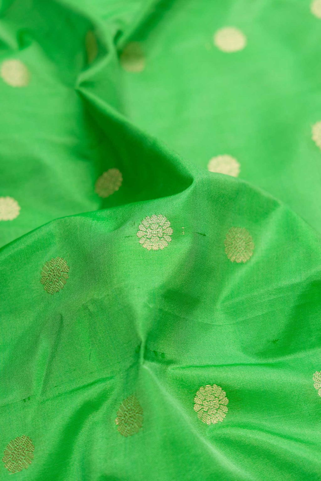 Close up of Green Blended Bangalore Silk Saree with Zari Butta on the body and Zari Border displaying folds