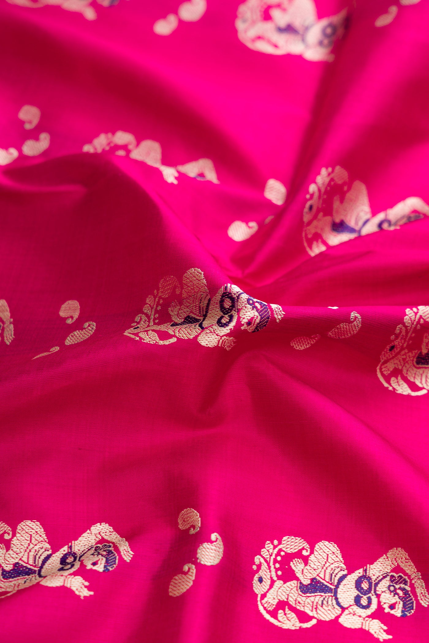 Close up of Pink Dual Tone Baluchari Silk Saree with Thread Butta on the body and Thread Border.  displaying folds