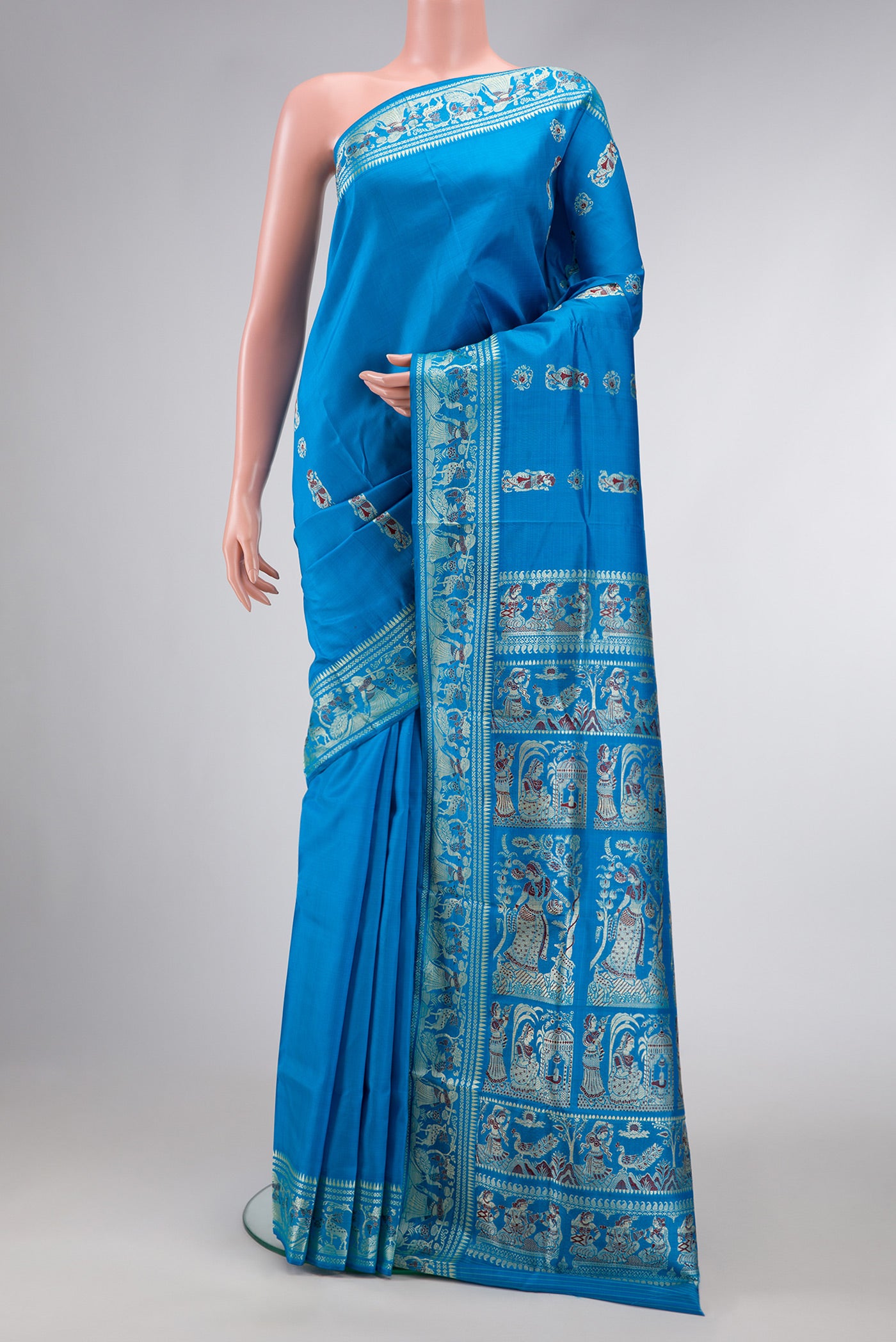 Sky Blue Dual Tone Baluchari Silk Saree with Thread Butta on the body and Thread Border.  displayed on a mannequin