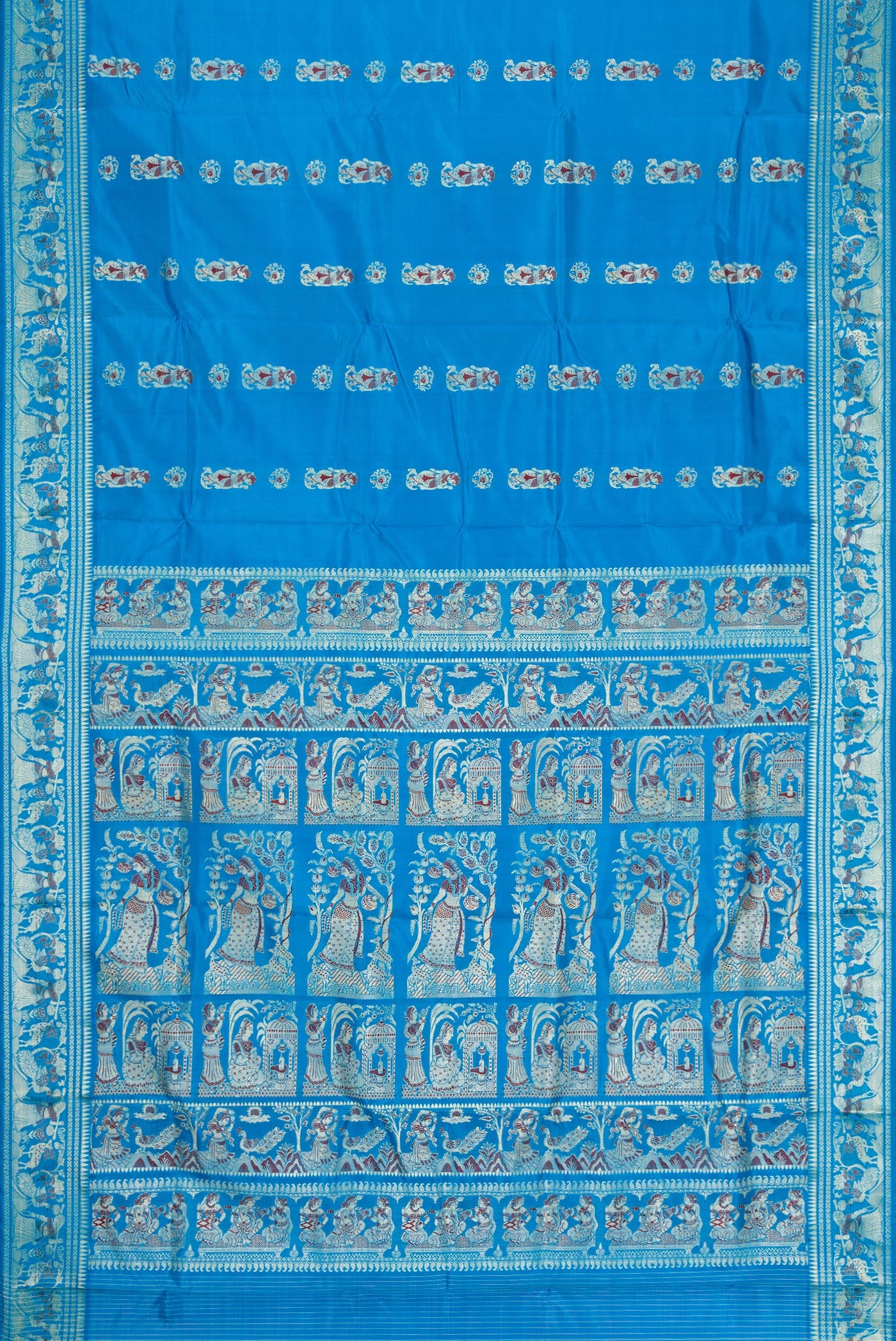 Flat view of Sky Blue Dual Tone Baluchari Silk Saree with Thread Butta on the body and Thread Border. 