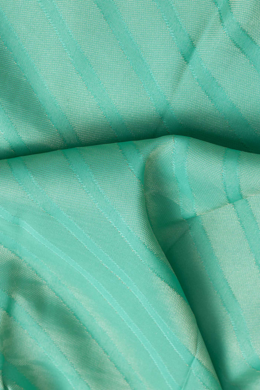 Close up of Sea Green Dual Tone Tussar Silk Saree with Zari Brocade on the body and Zari Border.  displaying folds