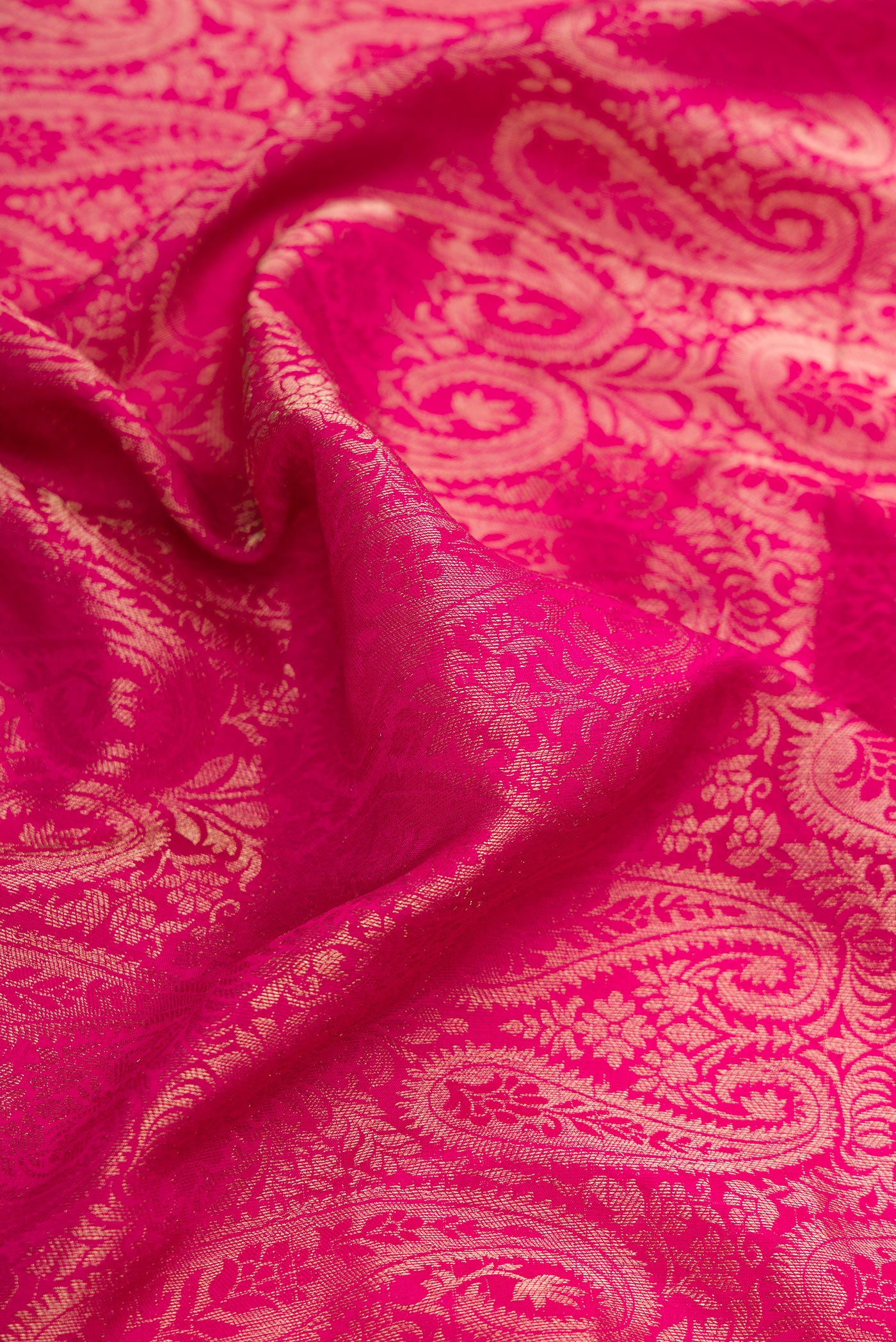 Close up of Pink Dual Tone Mysore Silk Saree with Zari Brocade on the body and Zari Border.  displaying folds