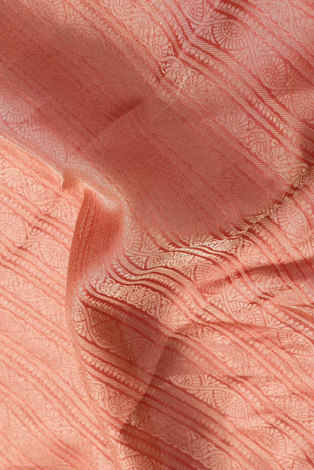 Close up of Golden Peach Dual Tone Tussar Silk Saree with Zari Brocade on the body and Zari Border.  displaying folds