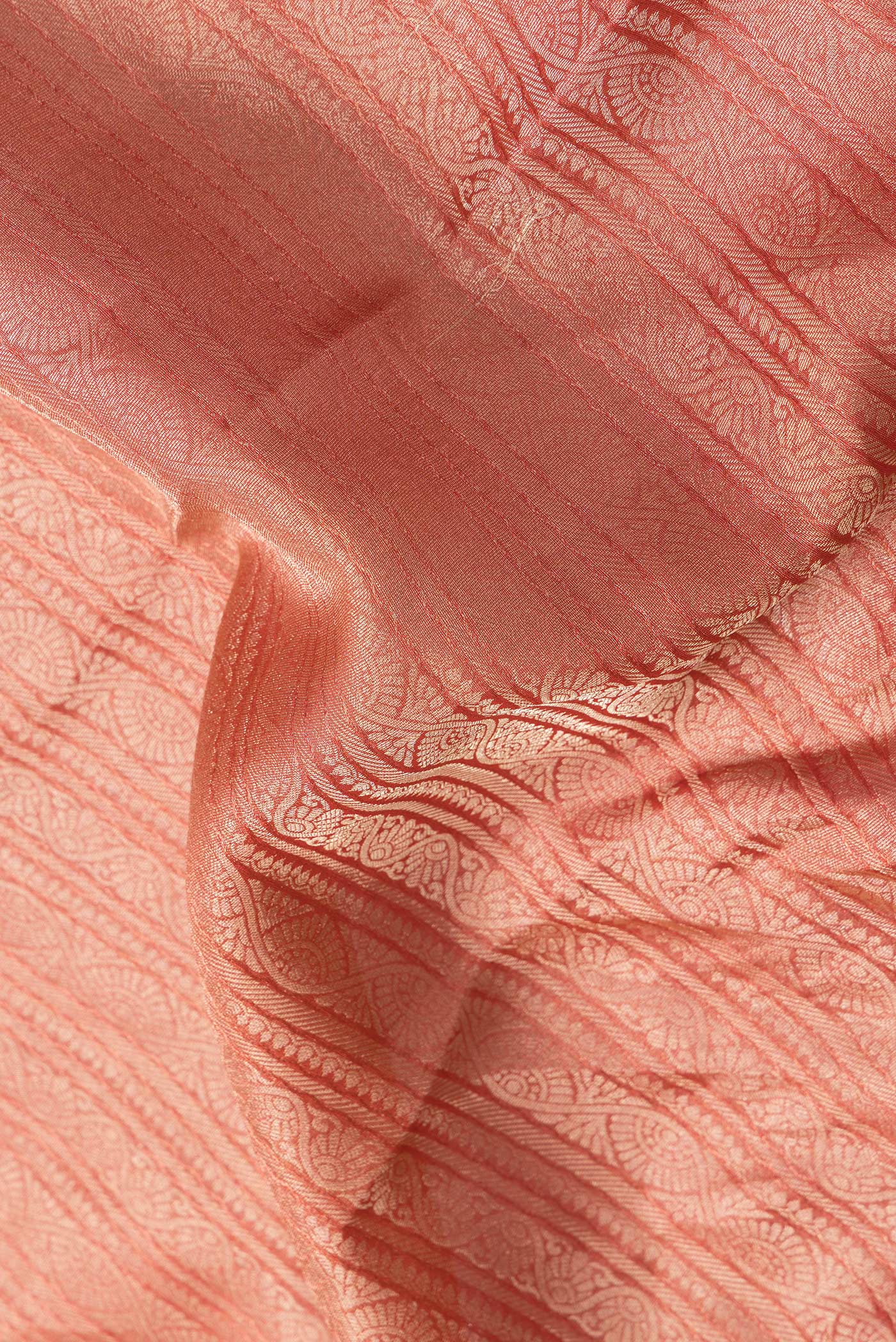 Close up of Golden Peach Dual Tone Tussar Silk Saree with Zari Brocade on the body and Zari Border.  displaying folds
