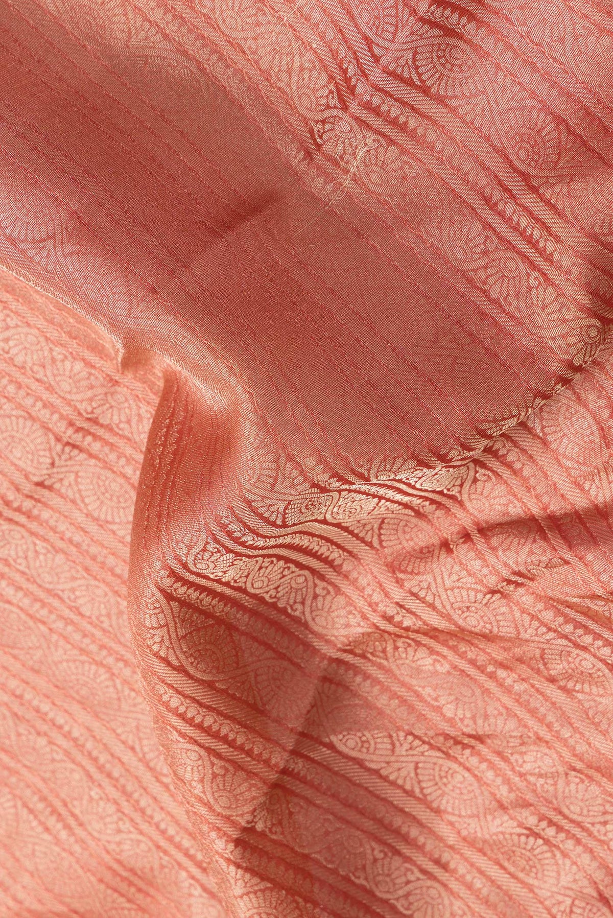 Close up of Golden Peach Dual Tone Tussar Silk Saree with Zari Brocade on the body and Zari Border.  displaying folds