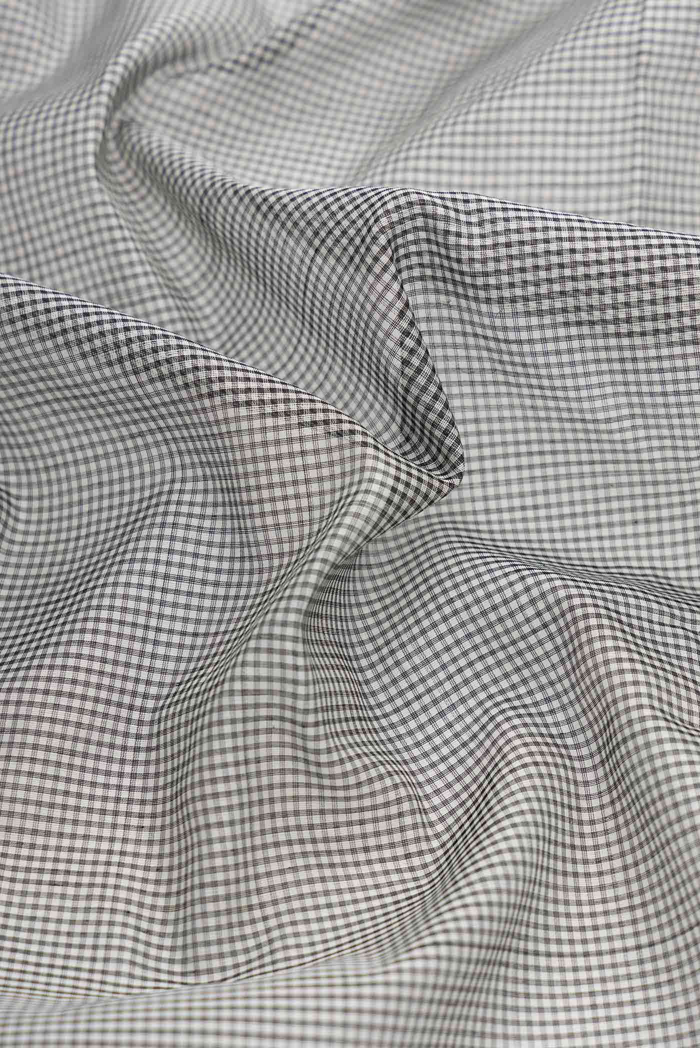 Close up of Grey Dual Tone Silk Cotton Saree with Checked design on the body and Zari Border displaying folds
