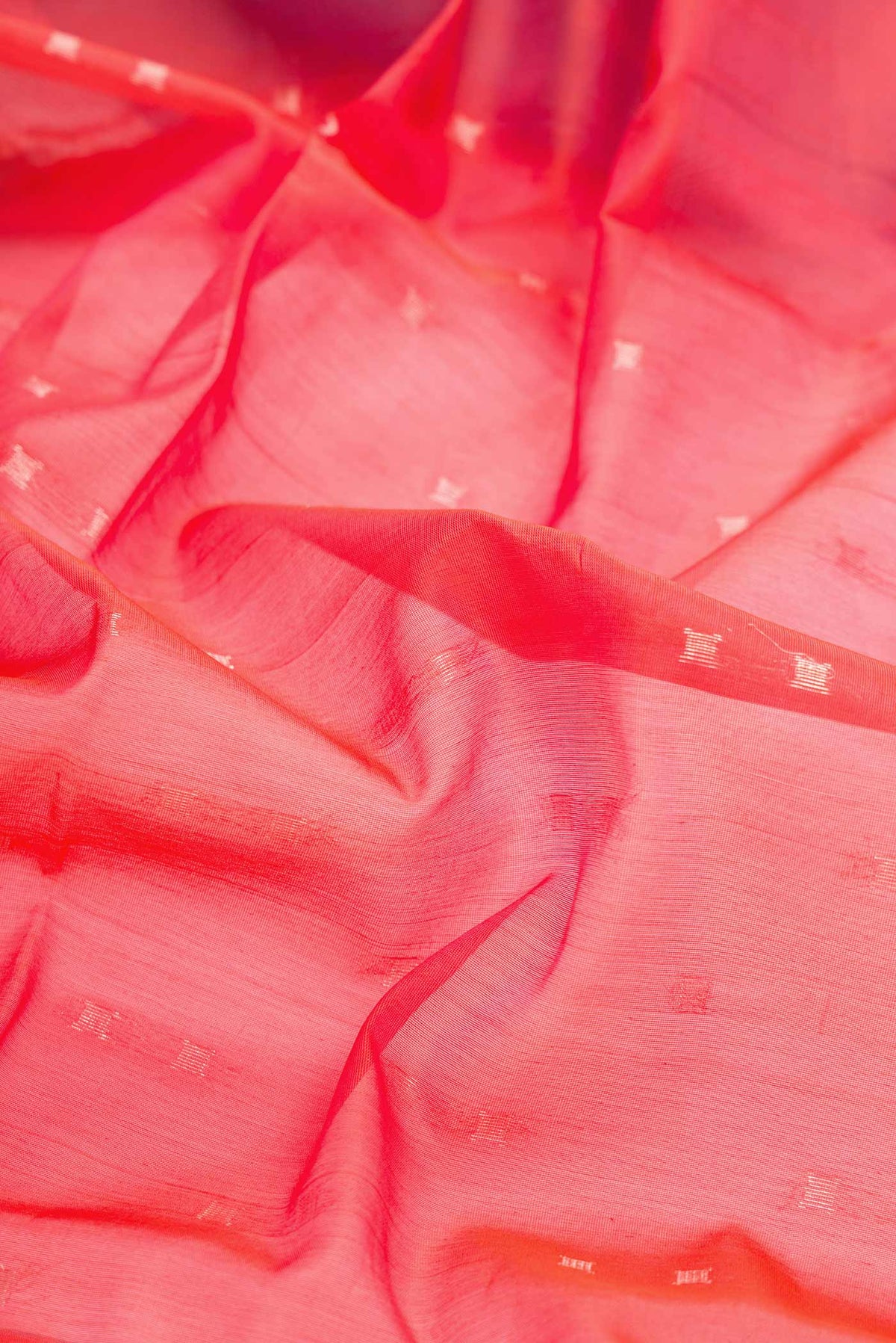 Close up of Orange Dual Tone Silk Cotton Saree with Zari Butta on the body and Zari Border displaying folds