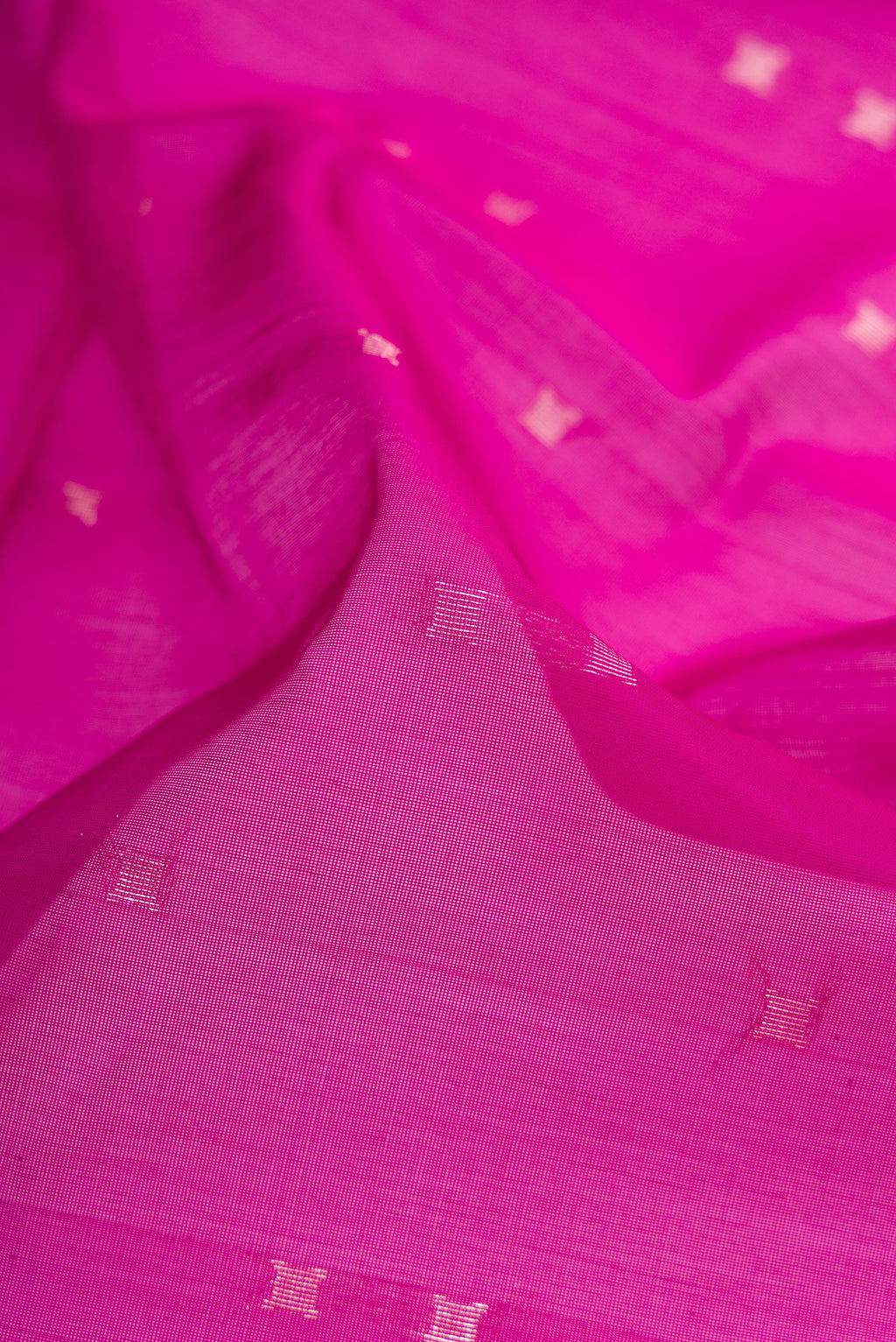 Close up of Magenta Silk Cotton Saree with Zari Butta on the body and Zari Border.  displaying folds