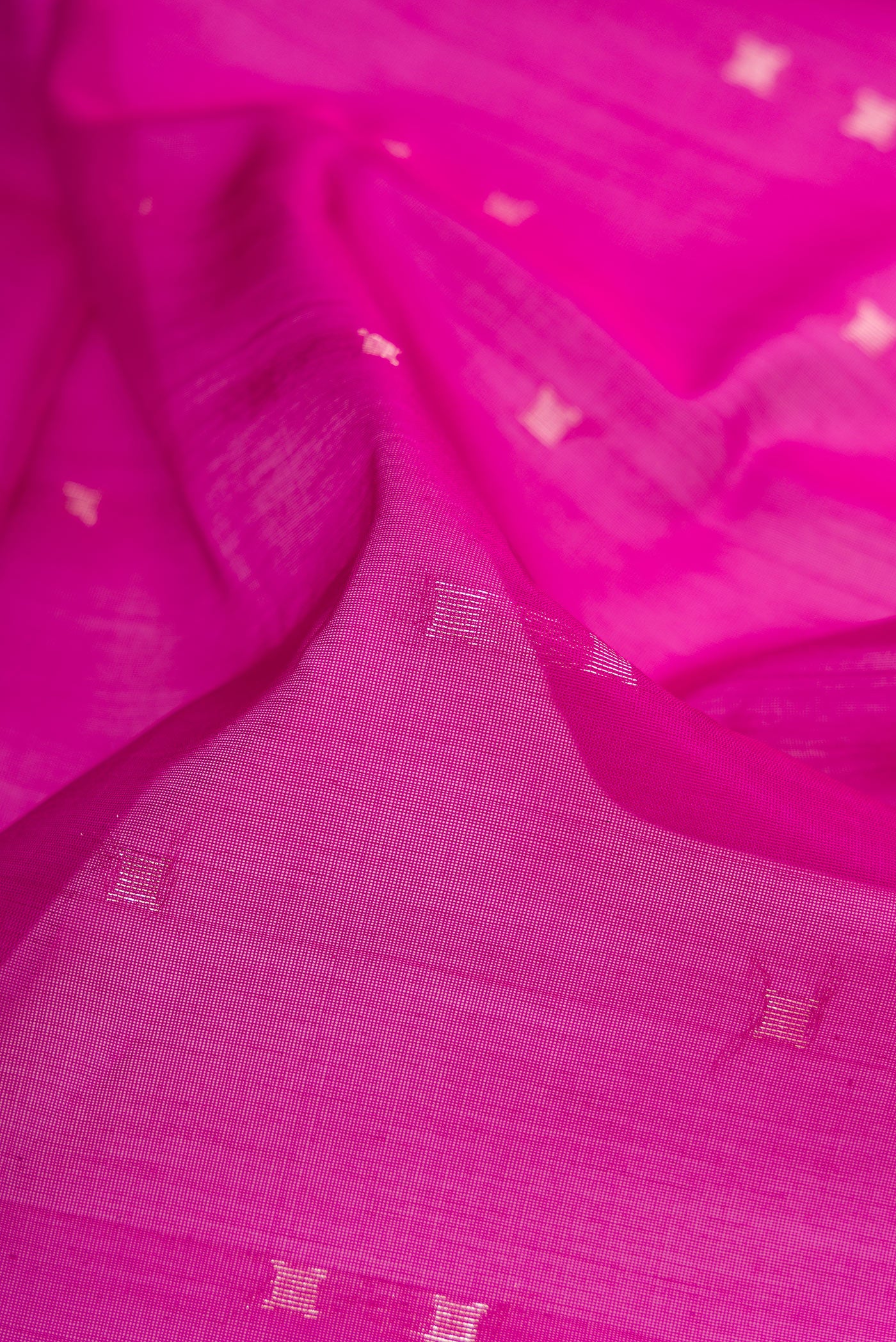 Close up of Magenta Silk Cotton Saree with Zari Butta on the body and Zari Border.  displaying folds