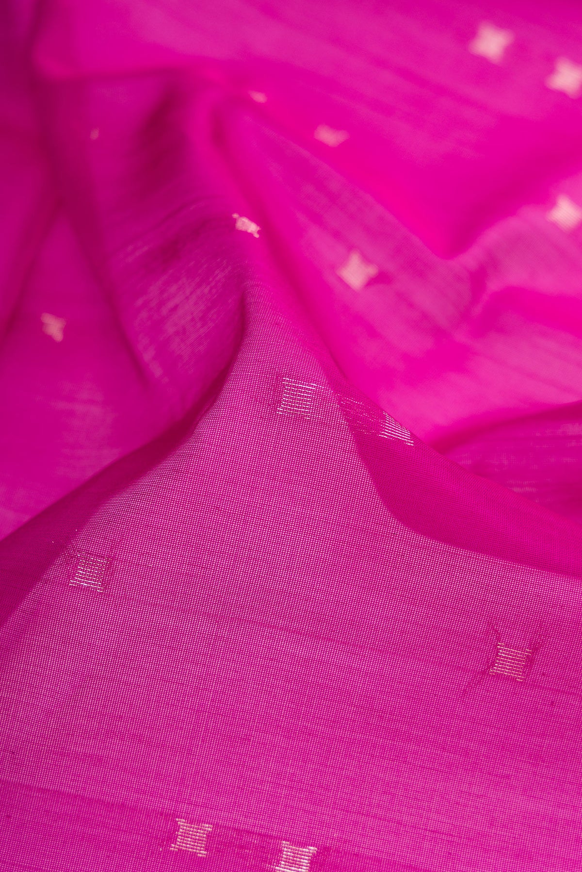 Close up of Magenta Silk Cotton Saree with Zari Butta on the body and Zari Border.  displaying folds