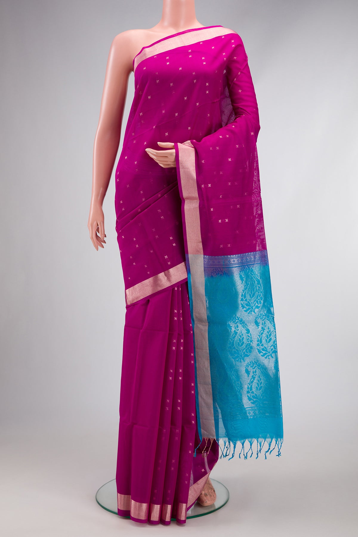 Magenta Silk Cotton Saree with Zari Butta on the body and Zari Border.  displayed on a mannequin