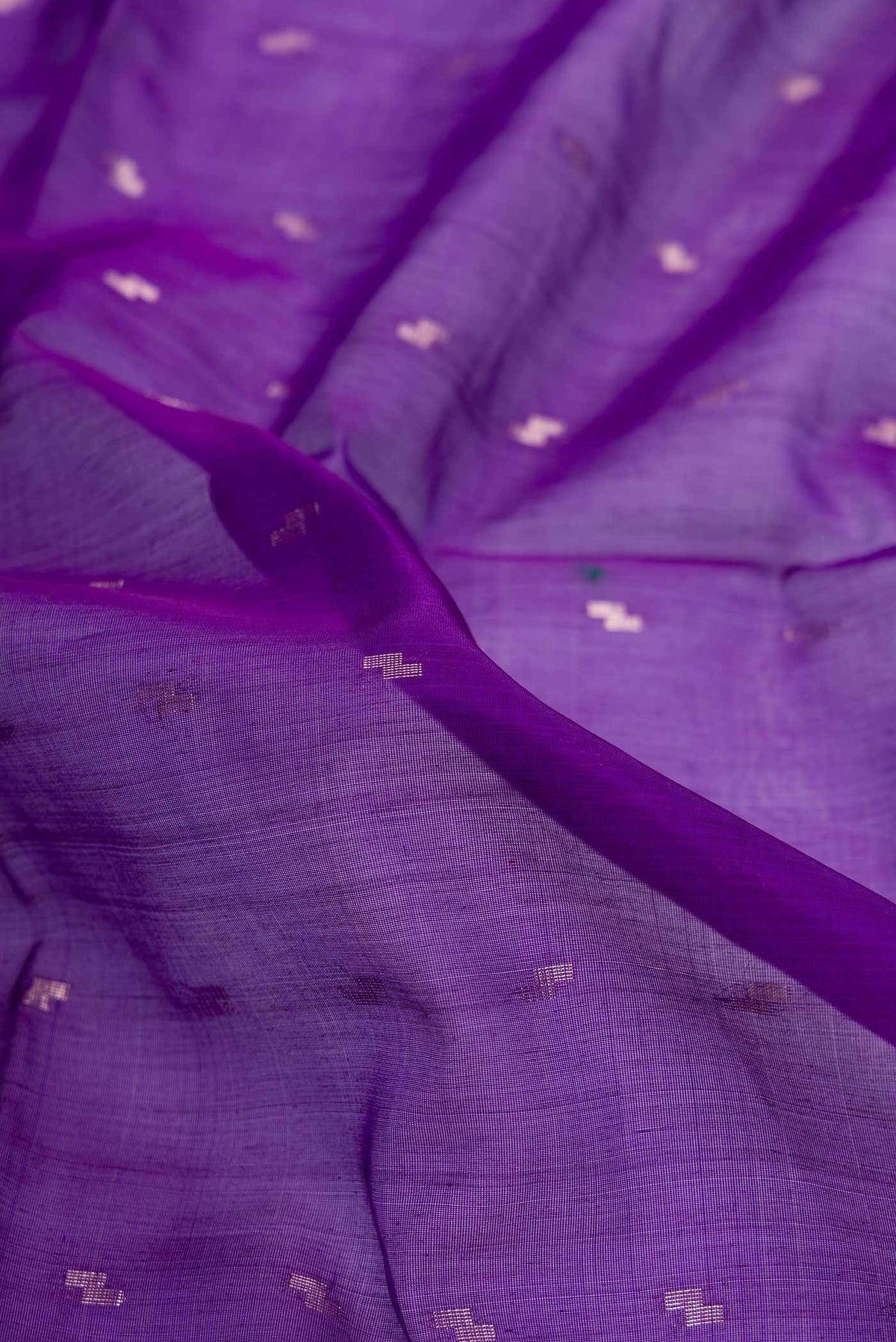 Close up of Violet Silk Cotton Saree with Zari Butta on the body and Zari Border displaying folds