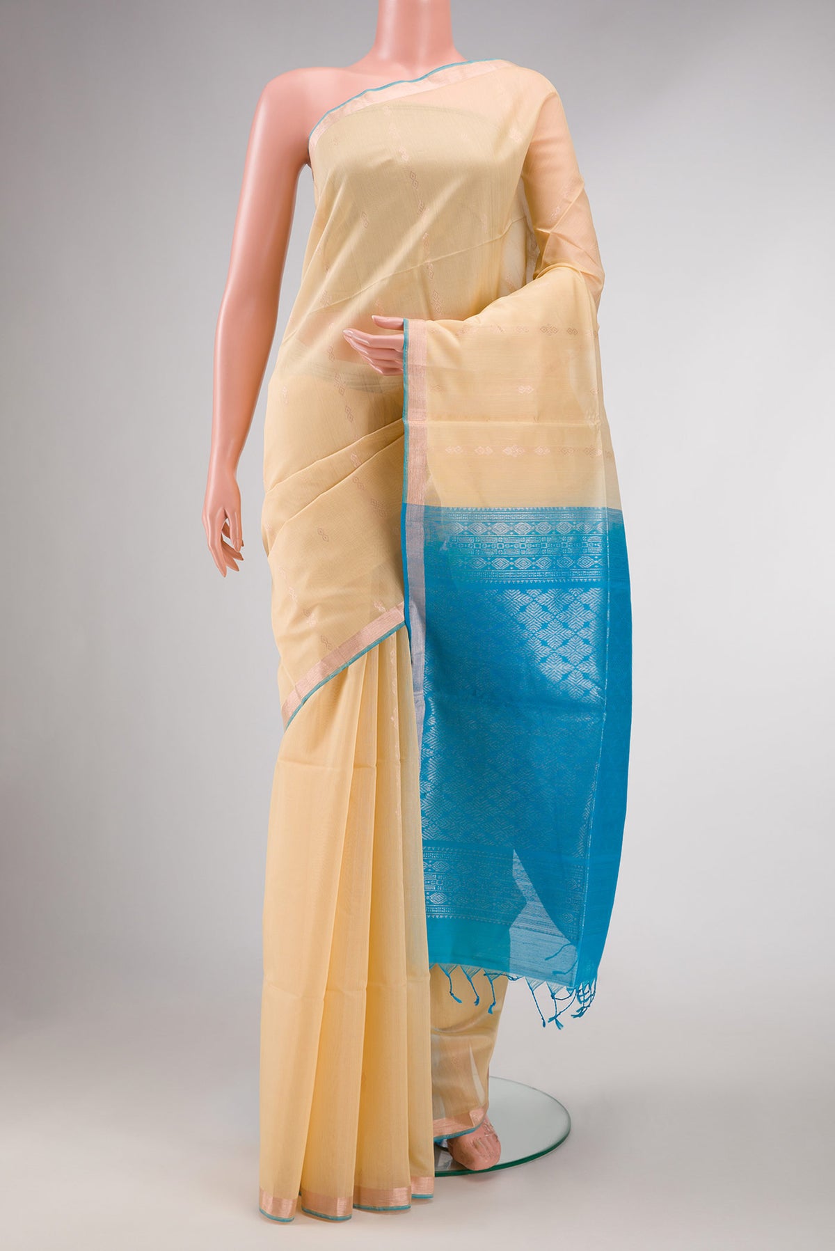 Sandal Dual Tone Silk Cotton Saree with Zari Butta on the body and Zari Border displayed on a mannequin