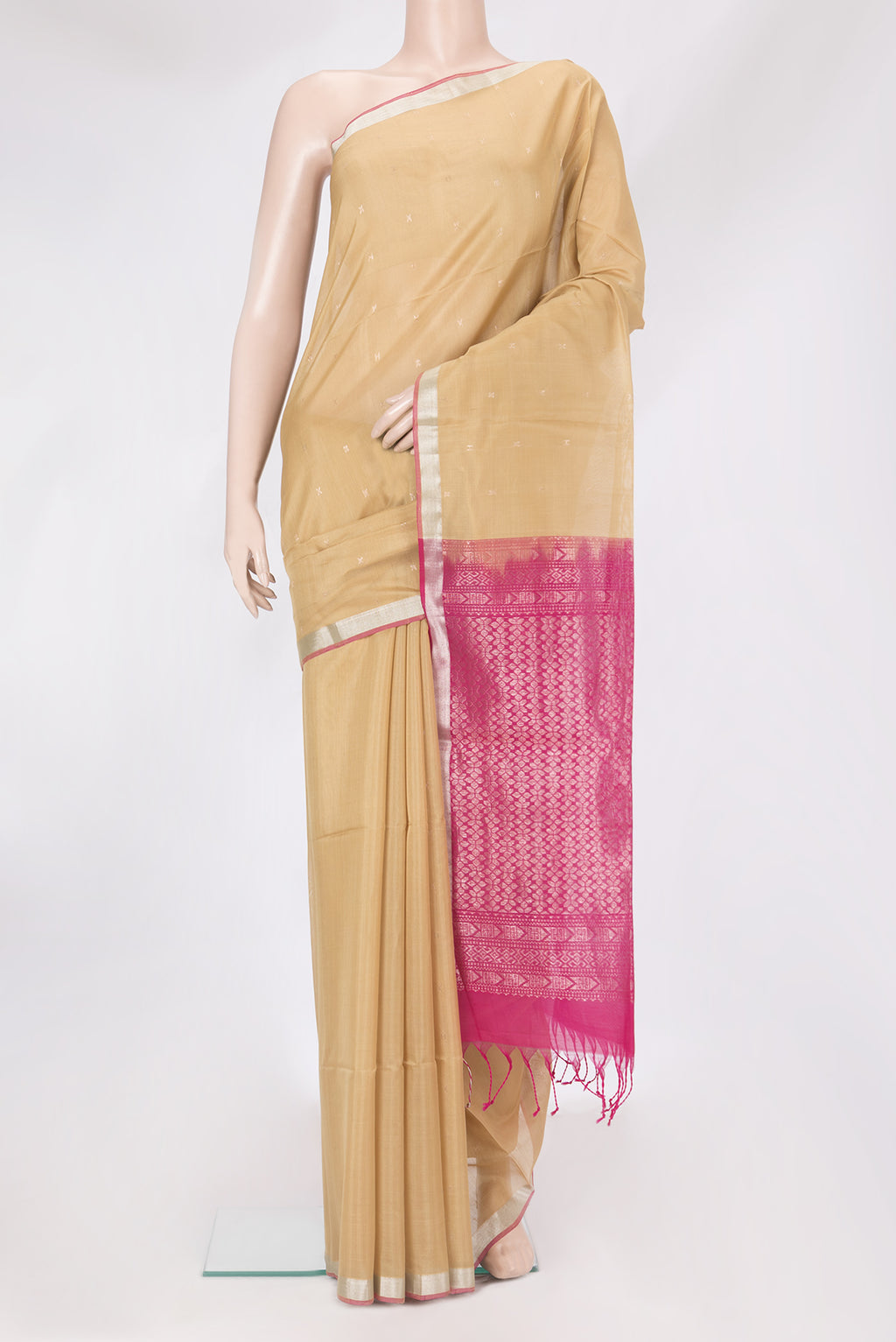 Beige Silk Cotton Saree with Zari Butta on the body and Zari Border.  displayed on a mannequin
