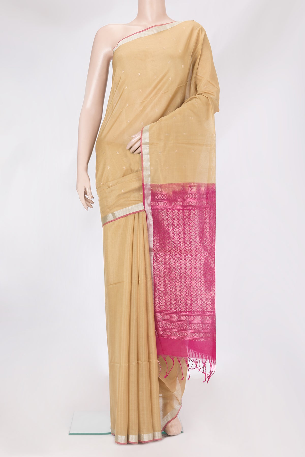 Beige Silk Cotton Saree with Zari Butta on the body and Zari Border.  displayed on a mannequin