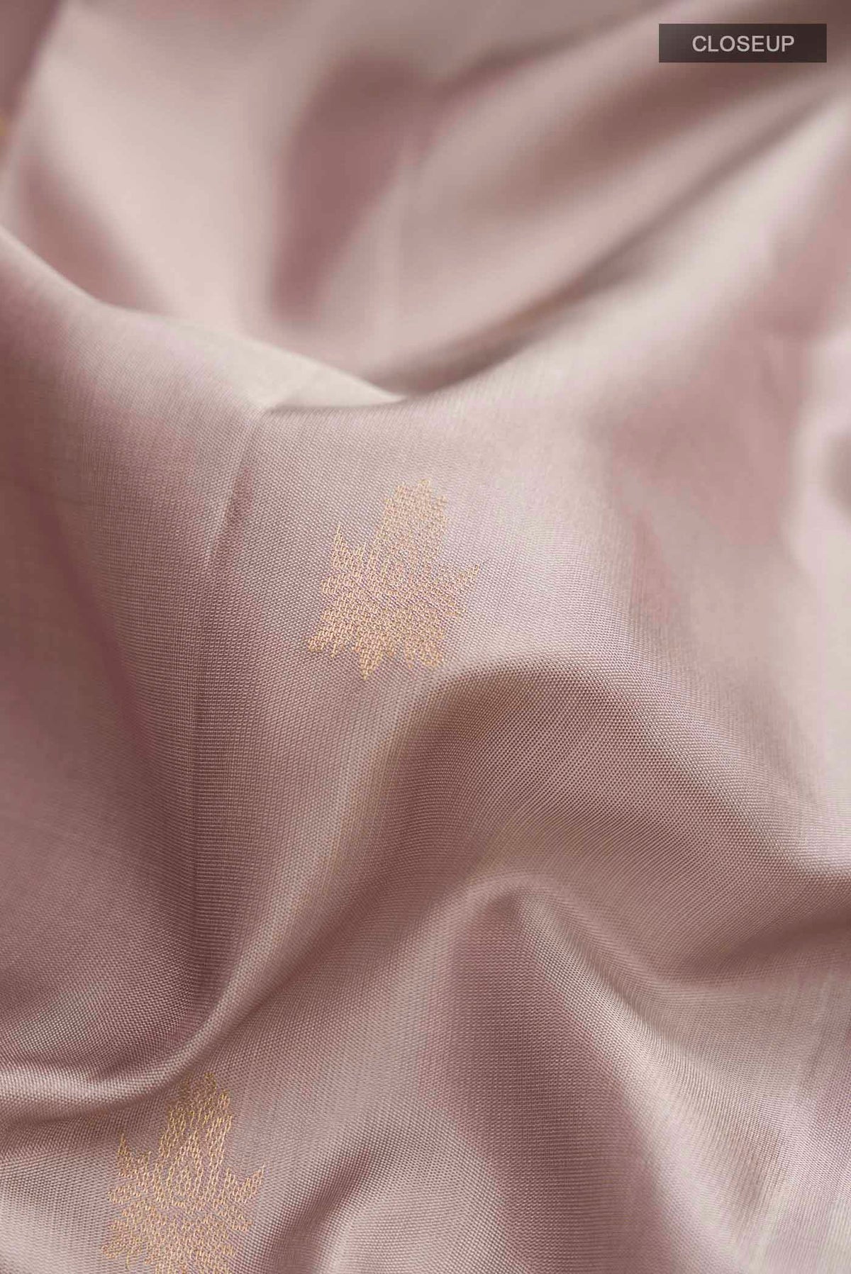 Close up of Grey Soft Silk Saree with Zari Butta on the body and Zari Border displaying folds