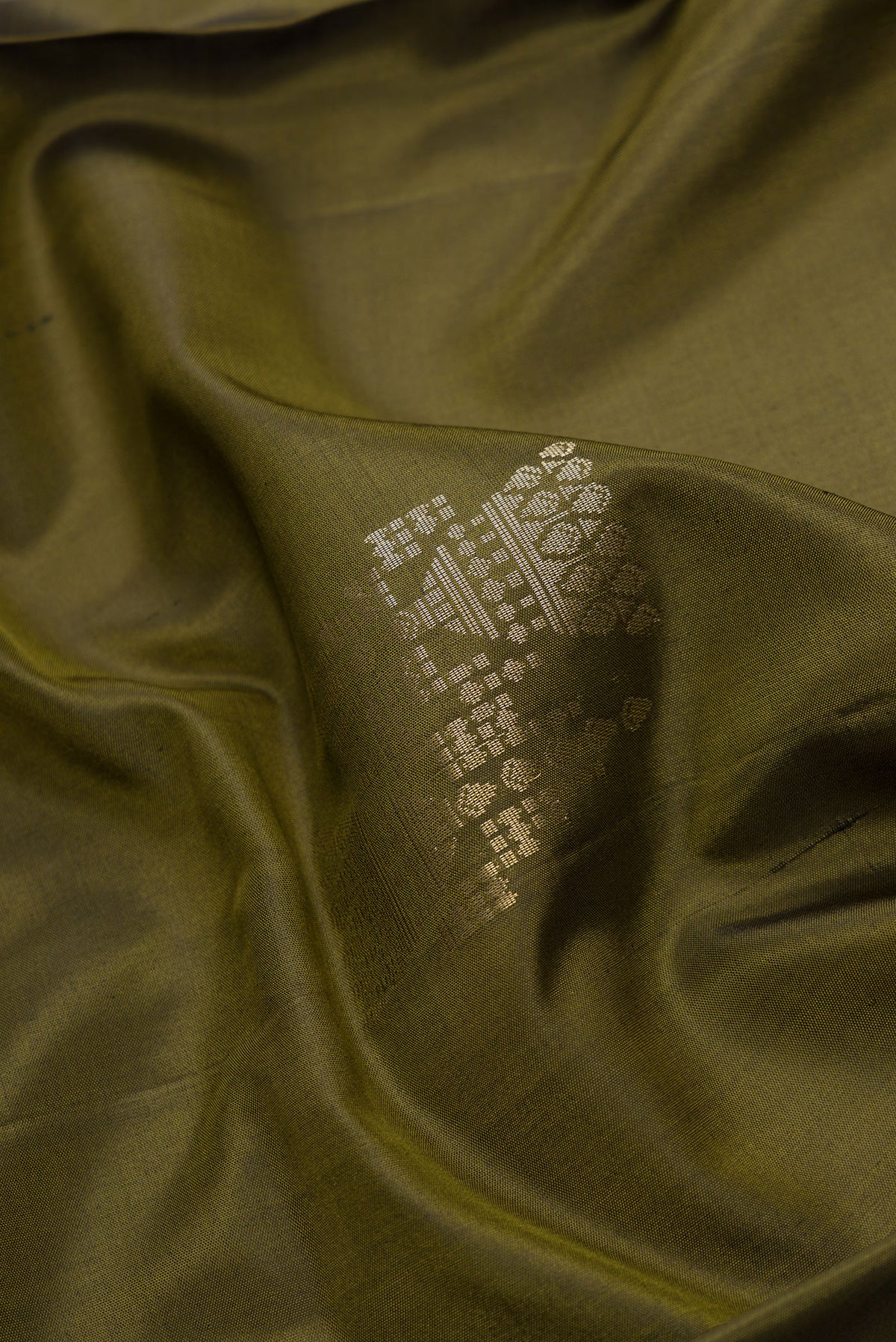 Close up of Mehandi Green Dual Tone Soft Silk Saree with Zari Butta on the body and Zari Border.  displaying folds