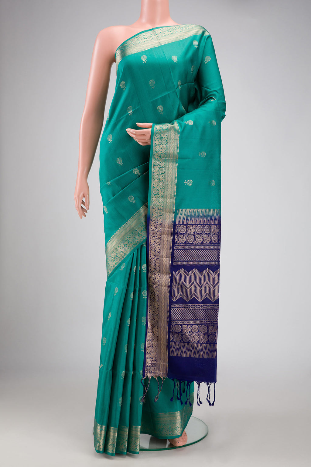 Green Dual Tone Soft Silk Saree with Zari Butta on the body and Zari Border.  displayed on a mannequin