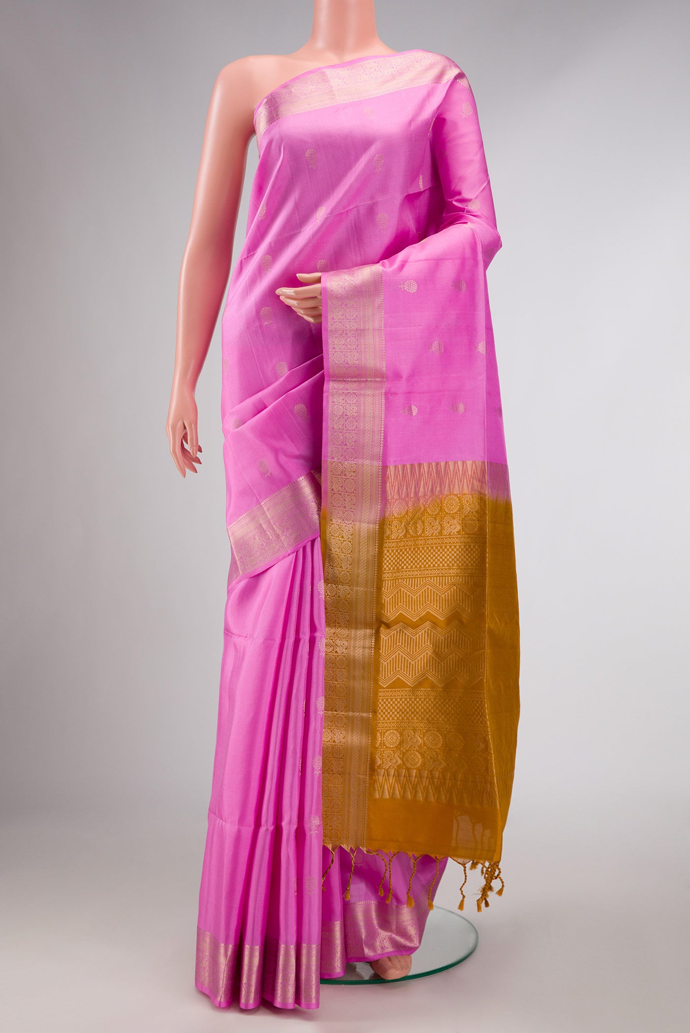 Rose pink Soft Silk Saree with Zari Butta on the body and Zari Border displayed on a mannequin
