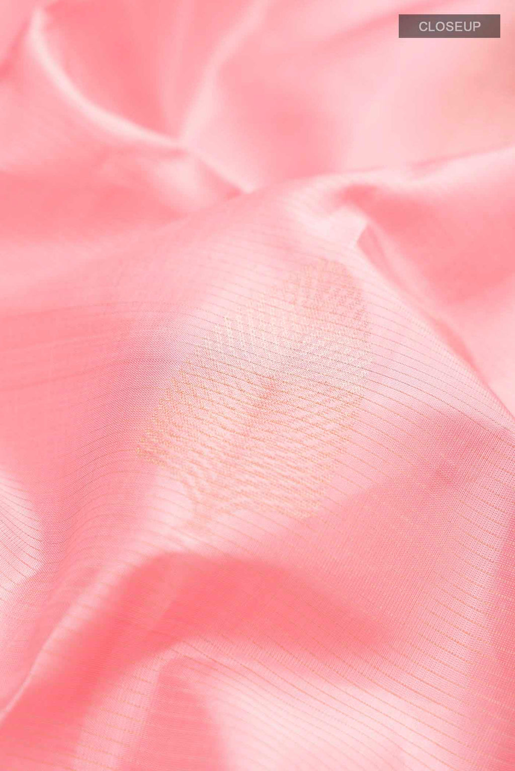 Close up of Rose pink Soft Silk Saree with Zari Butta on the body and Without Border displaying folds