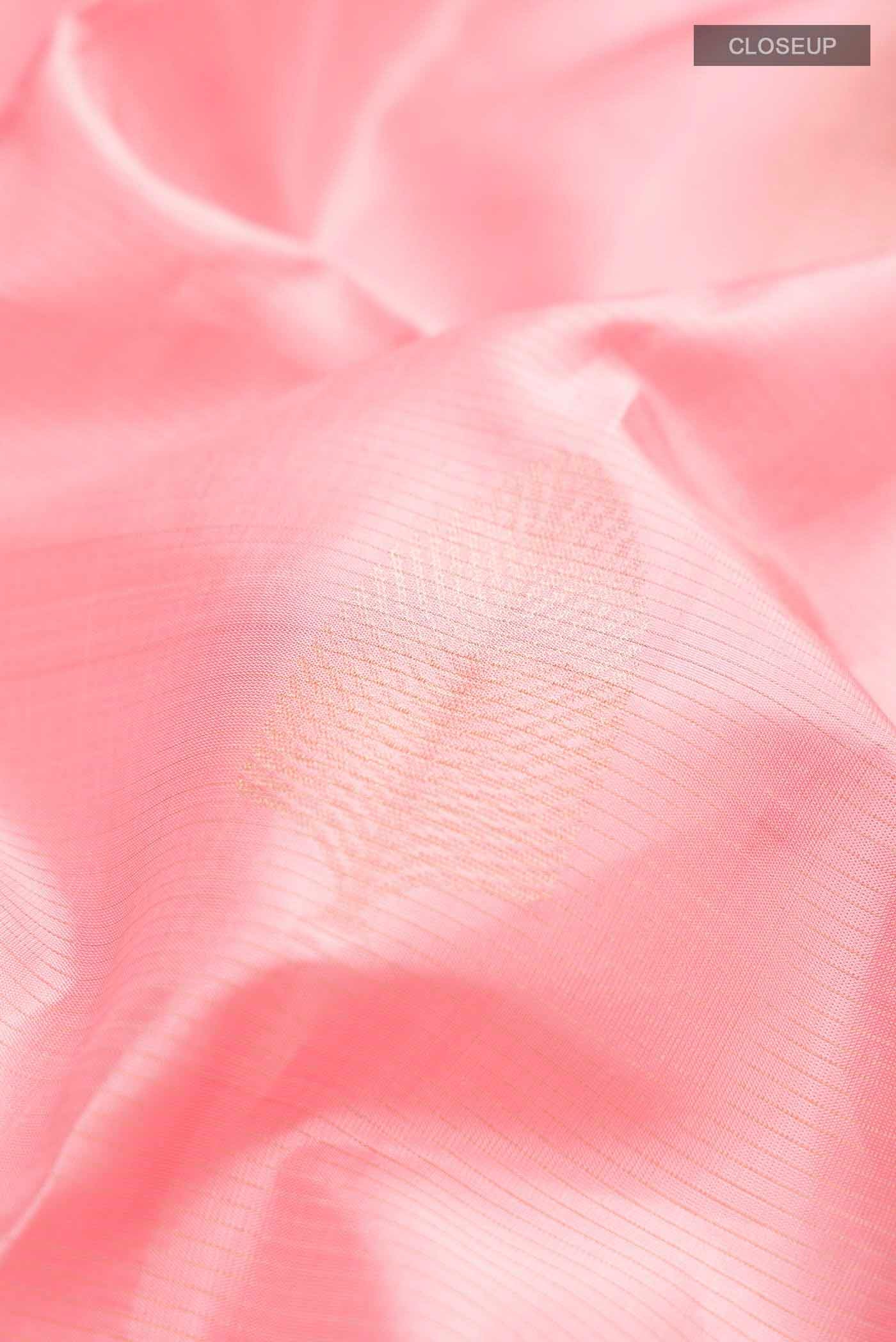 Close up of Rose pink Soft Silk Saree with Zari Butta on the body and Without Border displaying folds