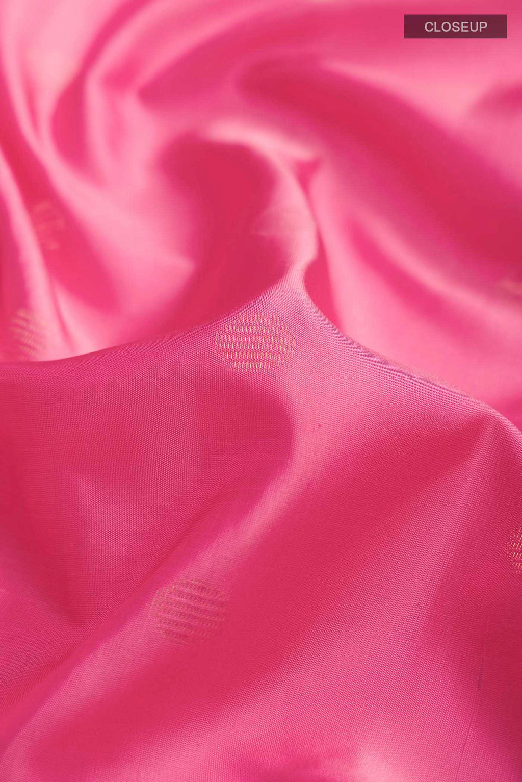 Close up of Pink Soft Silk Saree with Zari Butta on the body and Zari Border displaying folds